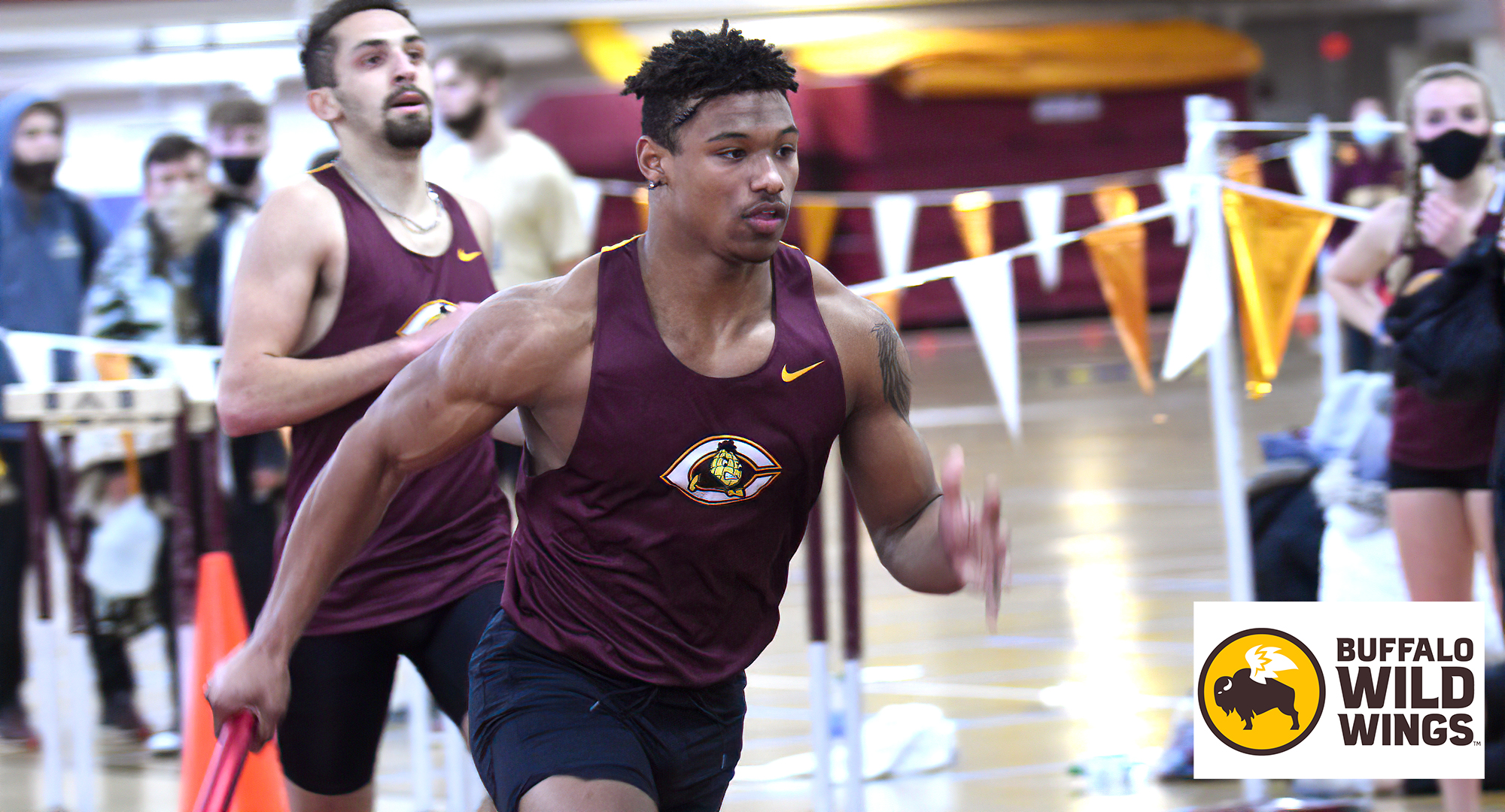Freshman Colin Conteh takes the baton for the second leg of the 4x400 relay. Conteh ran the fourth fastest time in school history in the 60-meter dash.