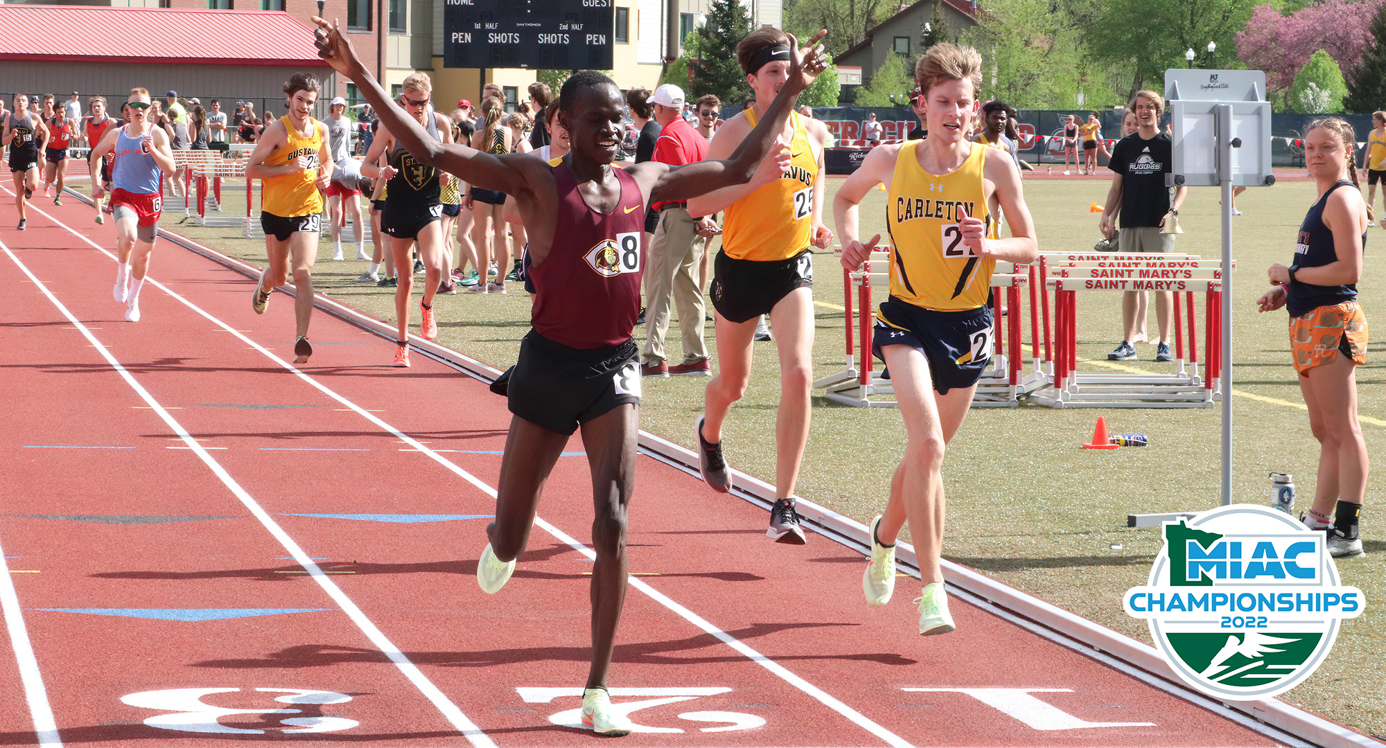 Munir Isahak raises his hands in victory after winning the 5K at the MIAC Outdoor Meet. He also won the 1500M. (Photo courtesy of St. Mary's SID)