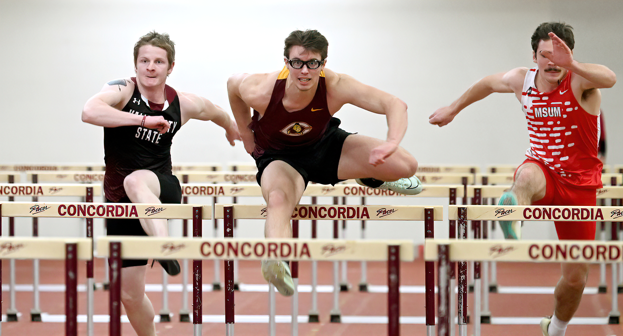 Logan Clark clears a hurdle on his way to winning the 60-meter hurdle event during the season-opening Cobber Open.