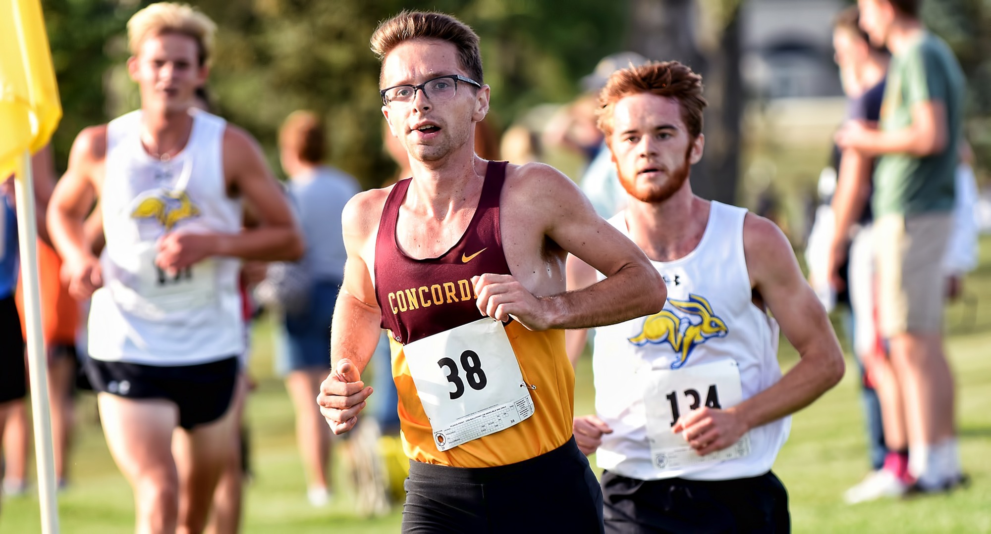 Senior Eric Wicklund rounds the corner in front of a pair of runners from DI SDSU at the season-opening Bison Open.