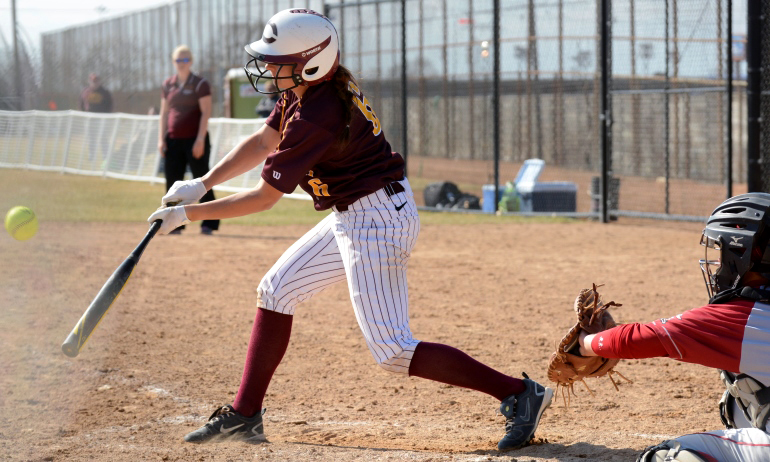 Madison Little pounds out one of her three hits in the series at Hamline. She has a six-game hit streak. (Photo courtesy of Hamline SID)