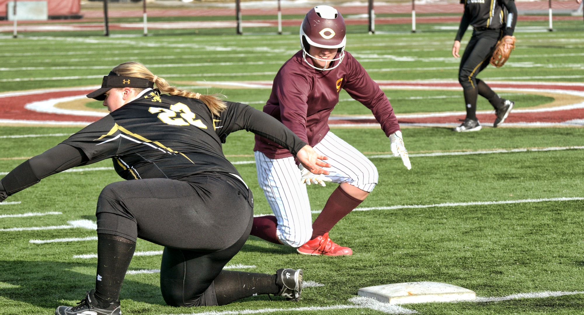 Nicole Johannes dives back into first base on an attempted pickoff play during the second game of the Cobbers' DH with St. Olaf.
