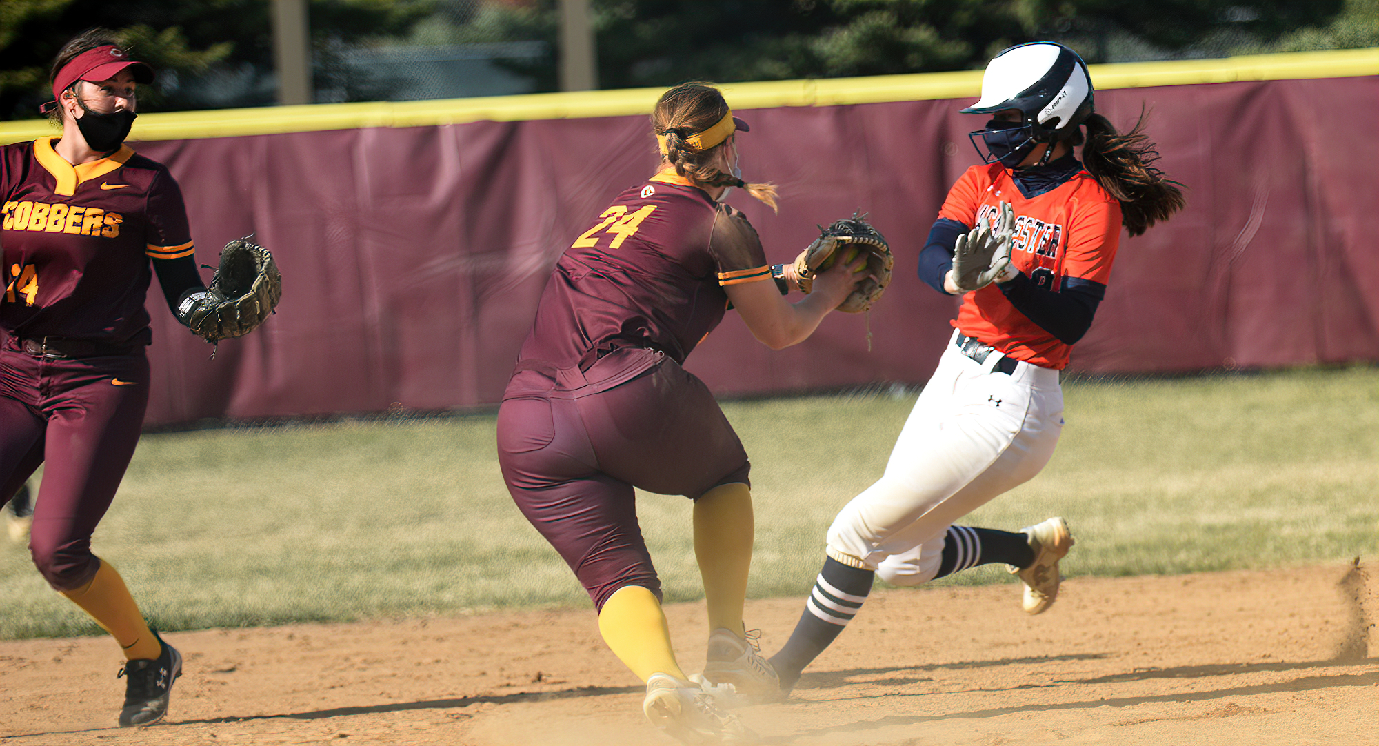 Taylor Erholtz goes to make the tag on a Macalester base runner at third base in the Cobbers' 3-2, 11-5 sweep over the Scots.