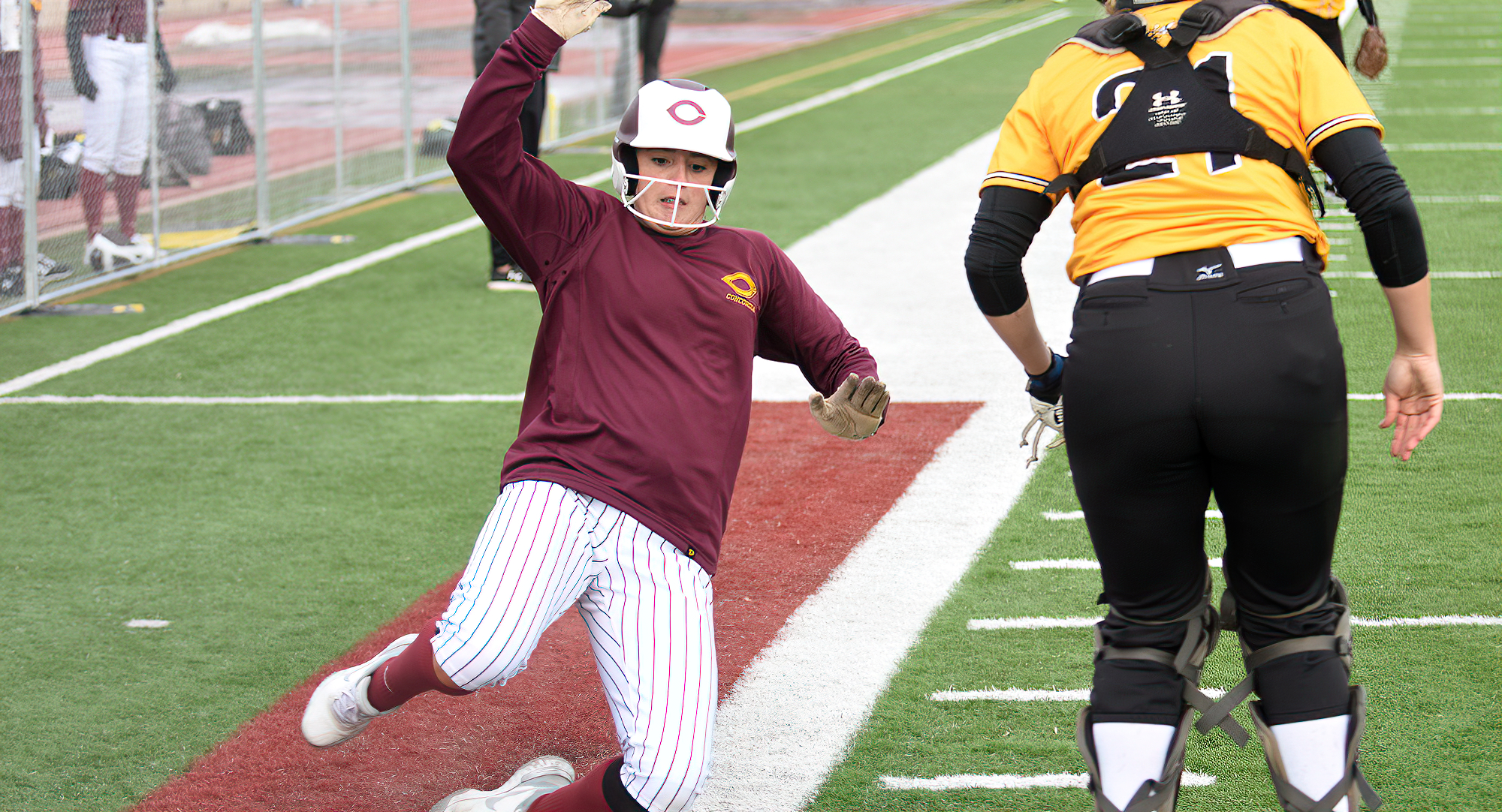 Kenzie Leither slides into home in Game 2 against UW-Superior. She went 3-for-5 on the day.