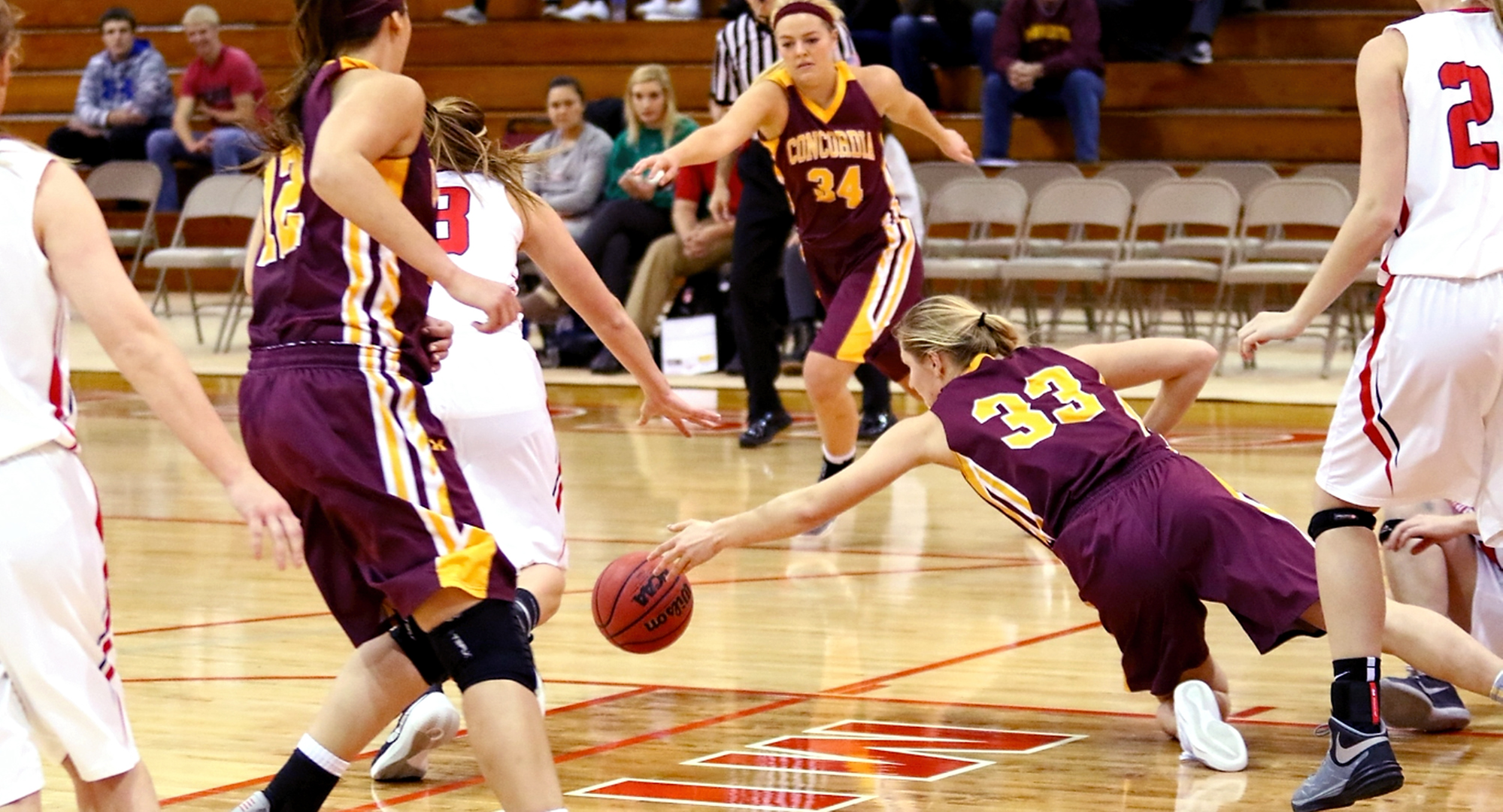 Senior Jenna Januschka dives on the floor after a loose ball in the Cobbers' game at St. Mary's. Januschka had a season-high 18 points for CC. (Photo courtesy of Ryan Coleman, D3photography.com)