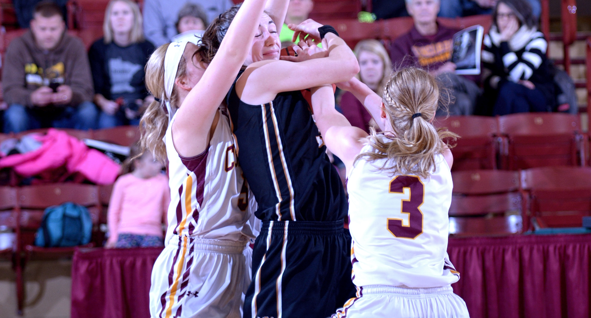 Concordia guards Lexi Nelson (L) and Greta Walsh pressure an Ole player with the ball during the Cobbers' gamer with St. Olaf.