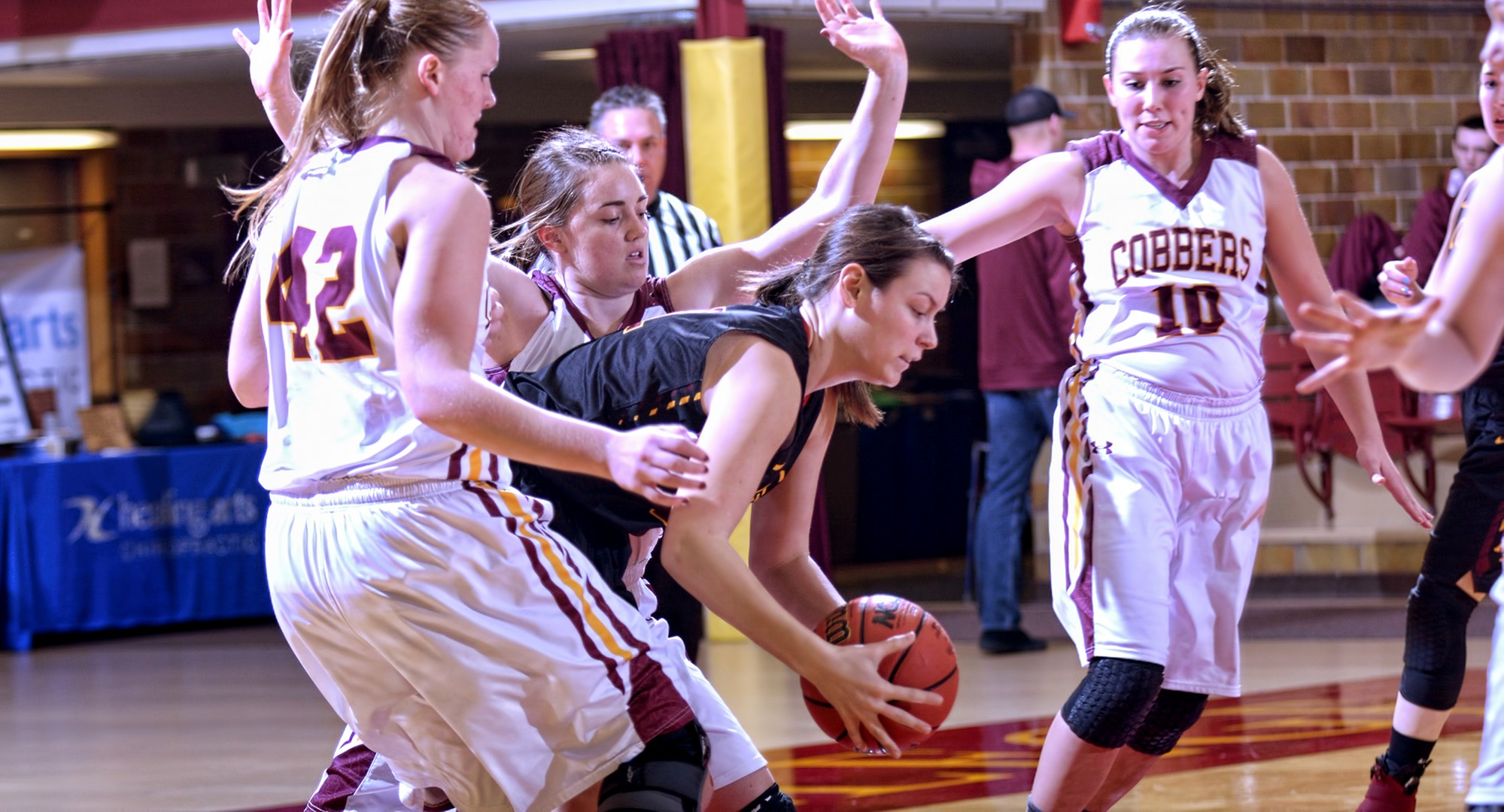 The Cobber defense led by Kirstin Simons (#42) collapses around a Minn.-Morris post player during Concordia's season-opening win over the Cougars.