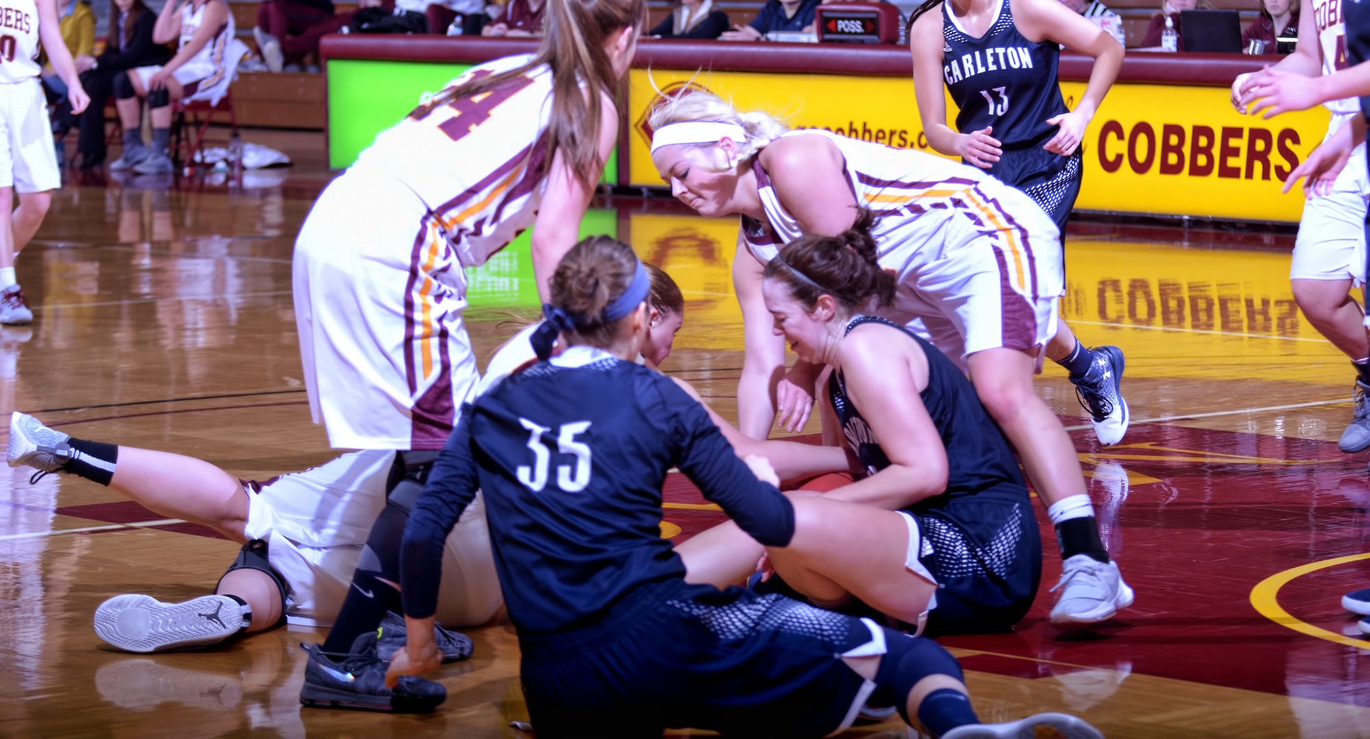 Players scramble to get control of the ball during the second quarter of the Cobbers' game with Carleton.