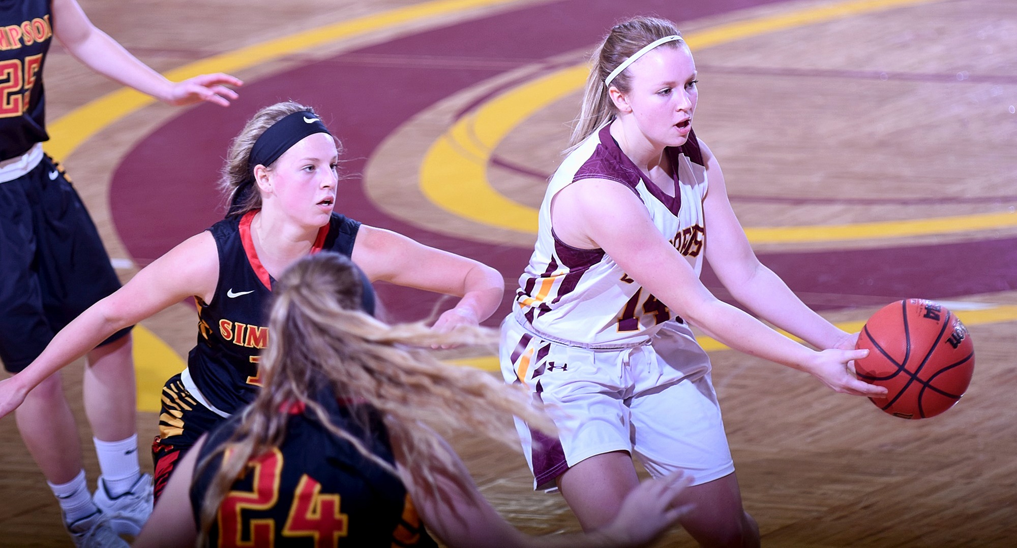 Freshman Avery Sundeen hands the ball off to a teammate during the second half of the Cobbers' non-conference game with Simpson. Sundeen finished with a career-high 14 points.