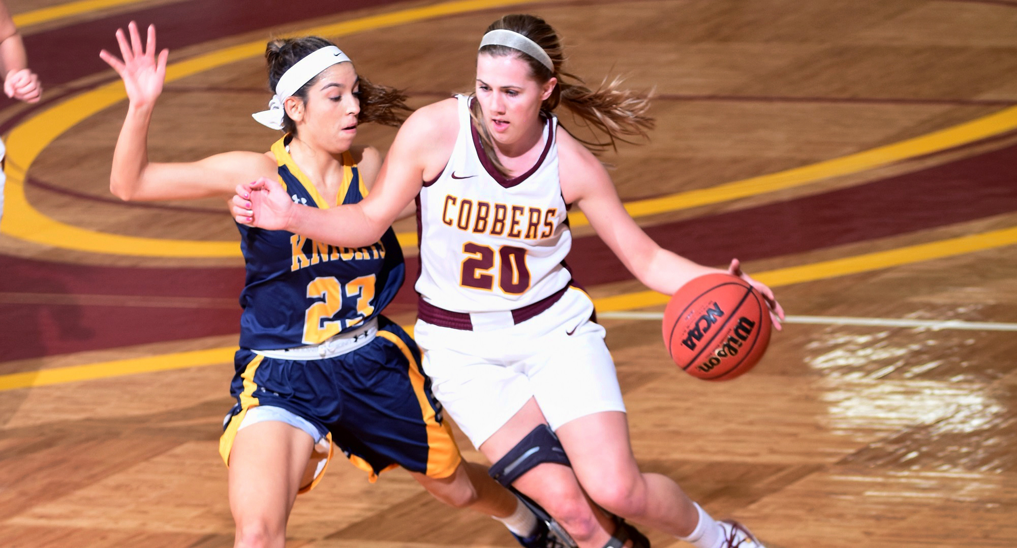 Freshman Emily Beseman drives to the basket during the first half of the Cobbers' win over Carleton. She broke a school record for most 3-point shots made in a single game.