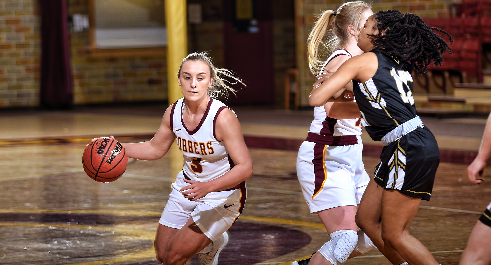 Sophomore Autumn Thompson cuts around a ball screen on the way to the basket in the first half of the Cobbers' OT win over St. Olaf. Thompson finished with a team-high 20 points.