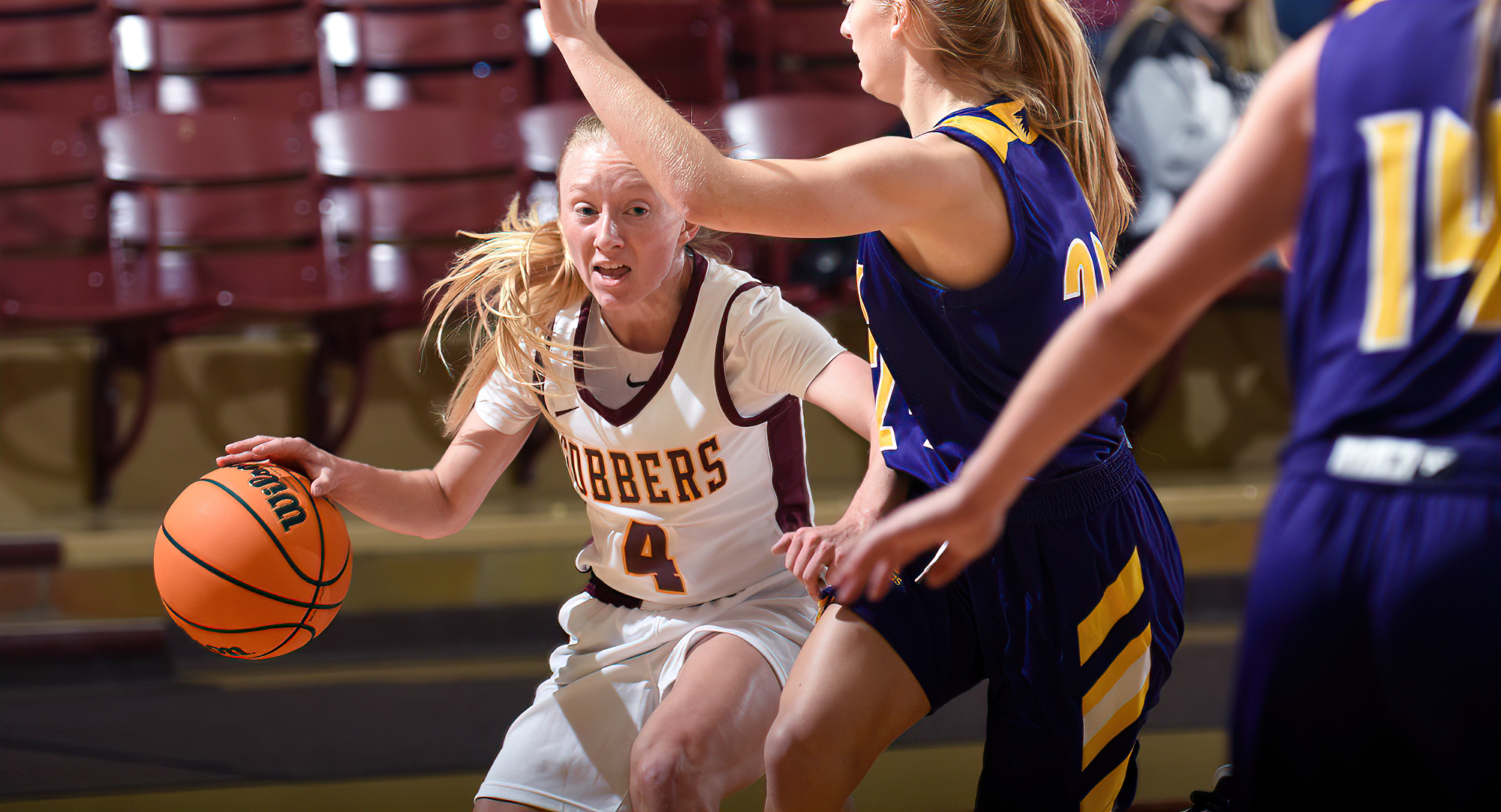 Sophomore guard Maddie Guler dribbles by a defender on her way to the basket in the Cobbers' 63-58 win over St. Catherine.