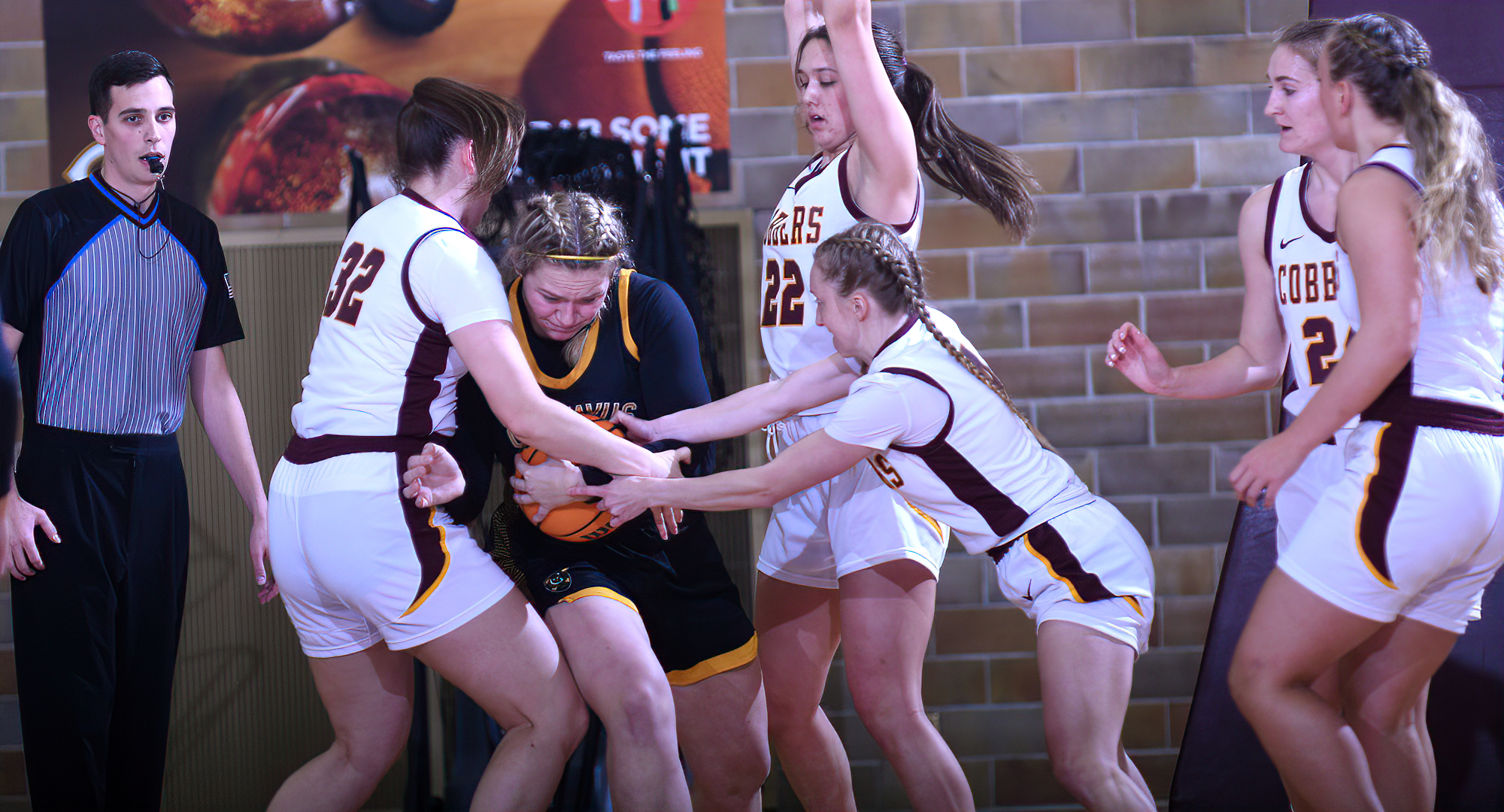 A trio of Cobber players defend a Gustavus player in Concordia's 64-63 win. CC forced 22 turnovers in the game which led to 28 points.