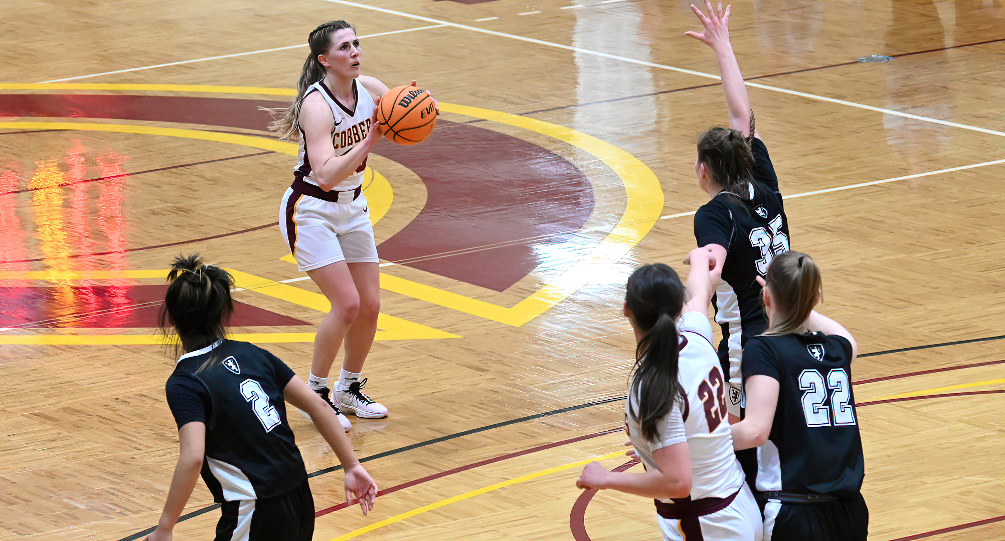 Senior Emily Beseman gets ready to drain one of her two shots from behind the arc in the Cobbers' win over St. olaf. She finished with 18 points.