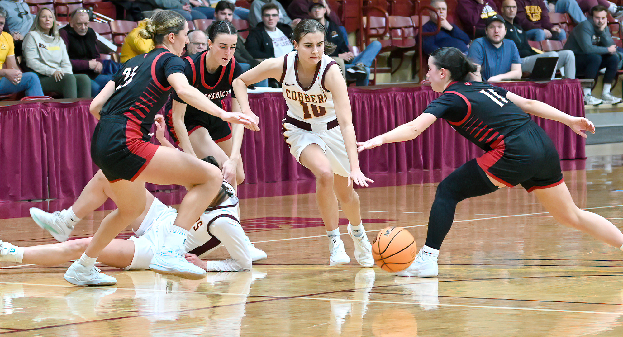 Carlee Sieben dribbles through a maze of St. Ben's players on her way to a layup in the Cobbers' win over the Bennies. She finished with 24 points.