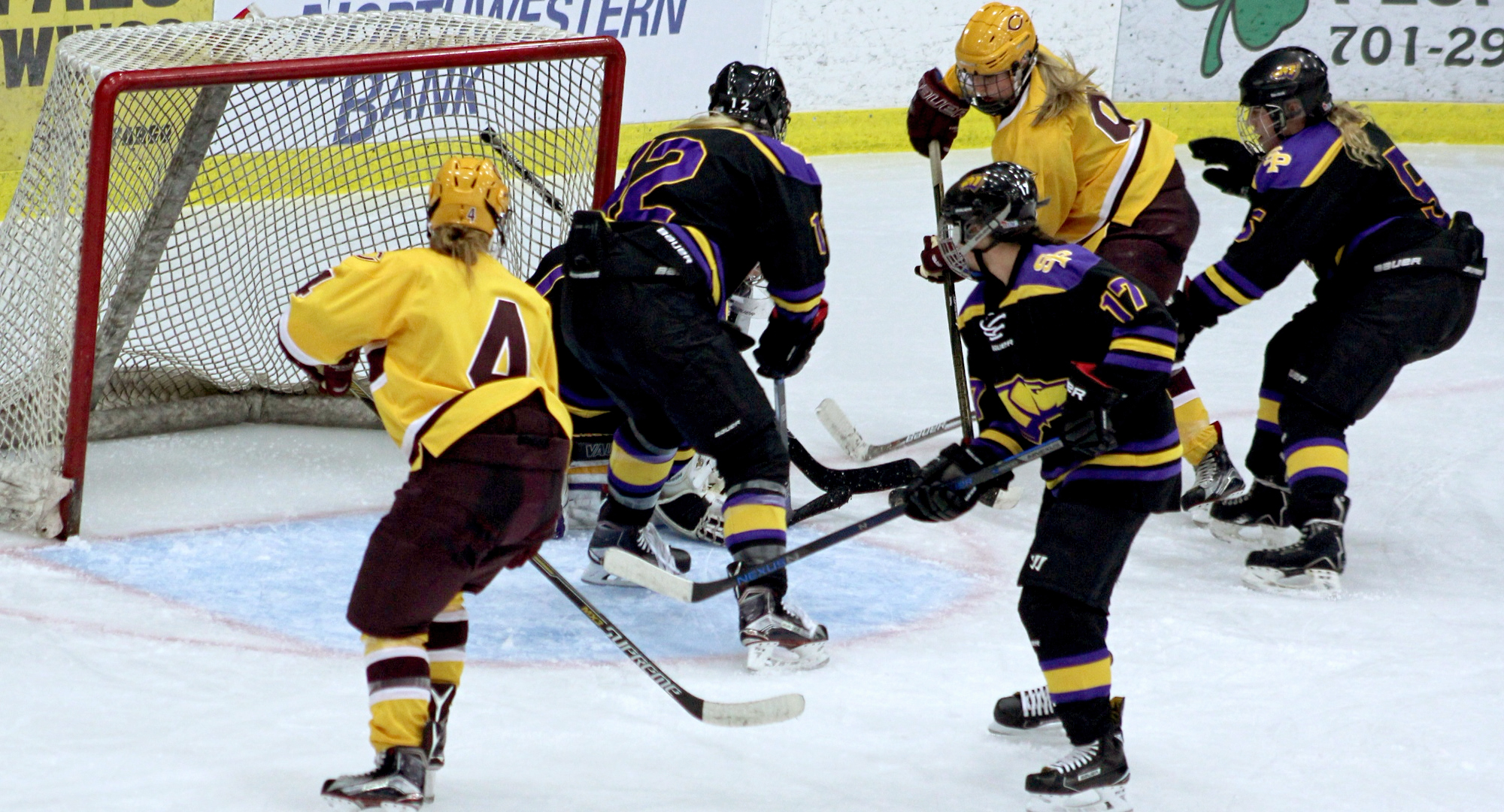 Cobber forwards Jess Nelson (#4) and Amber Schaack scramble for a loose puck around the Wis.-Stevens Point goal. The pair had two of the three goals in CC's 3-3 OT tie with the Pointers.