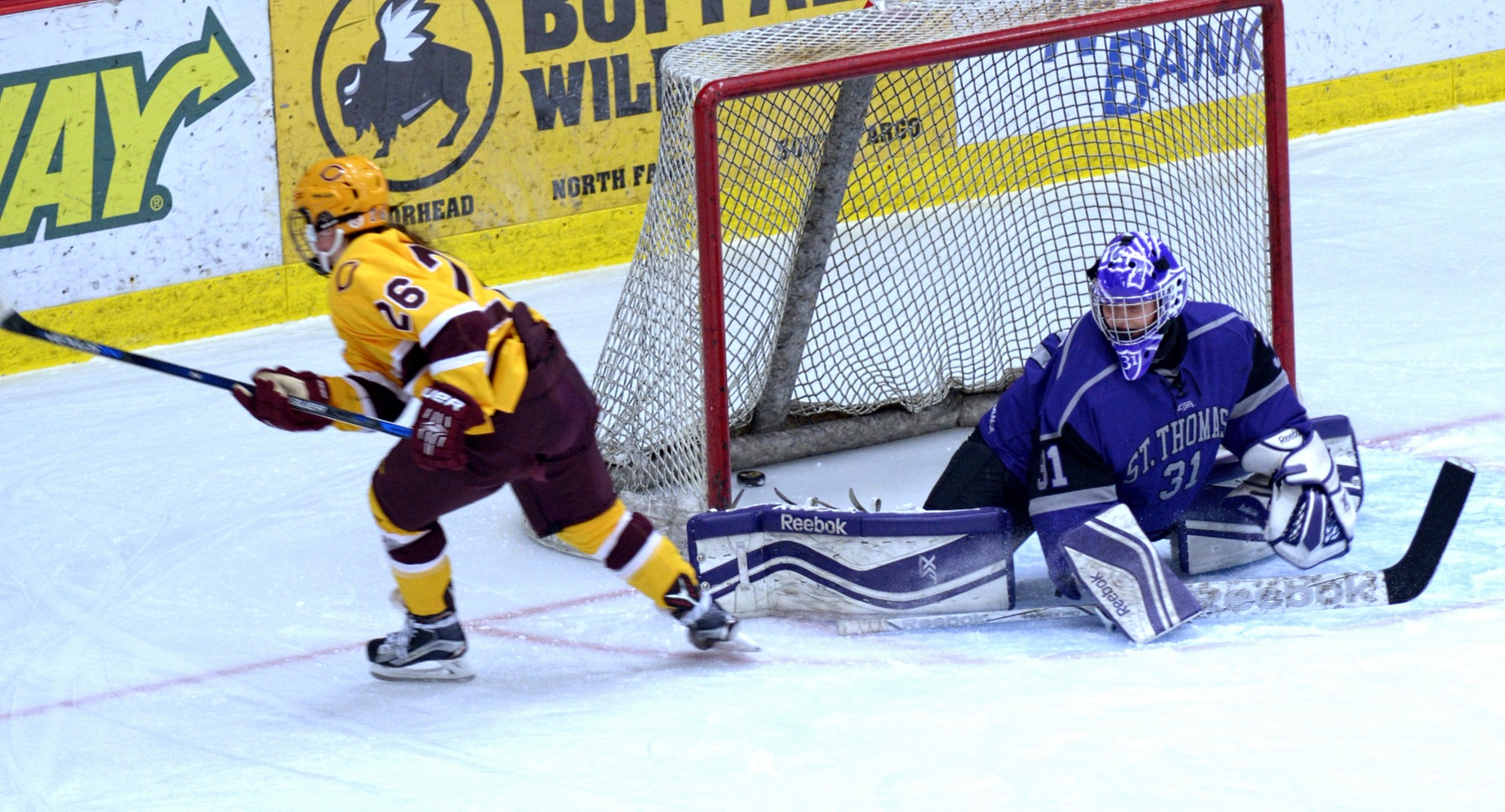 Junior Tori Davis slides the puck on a breakaway in the third period of the Cobbers' win over St. Thomas. The goal was the game winner and Davis' 10th of the year.