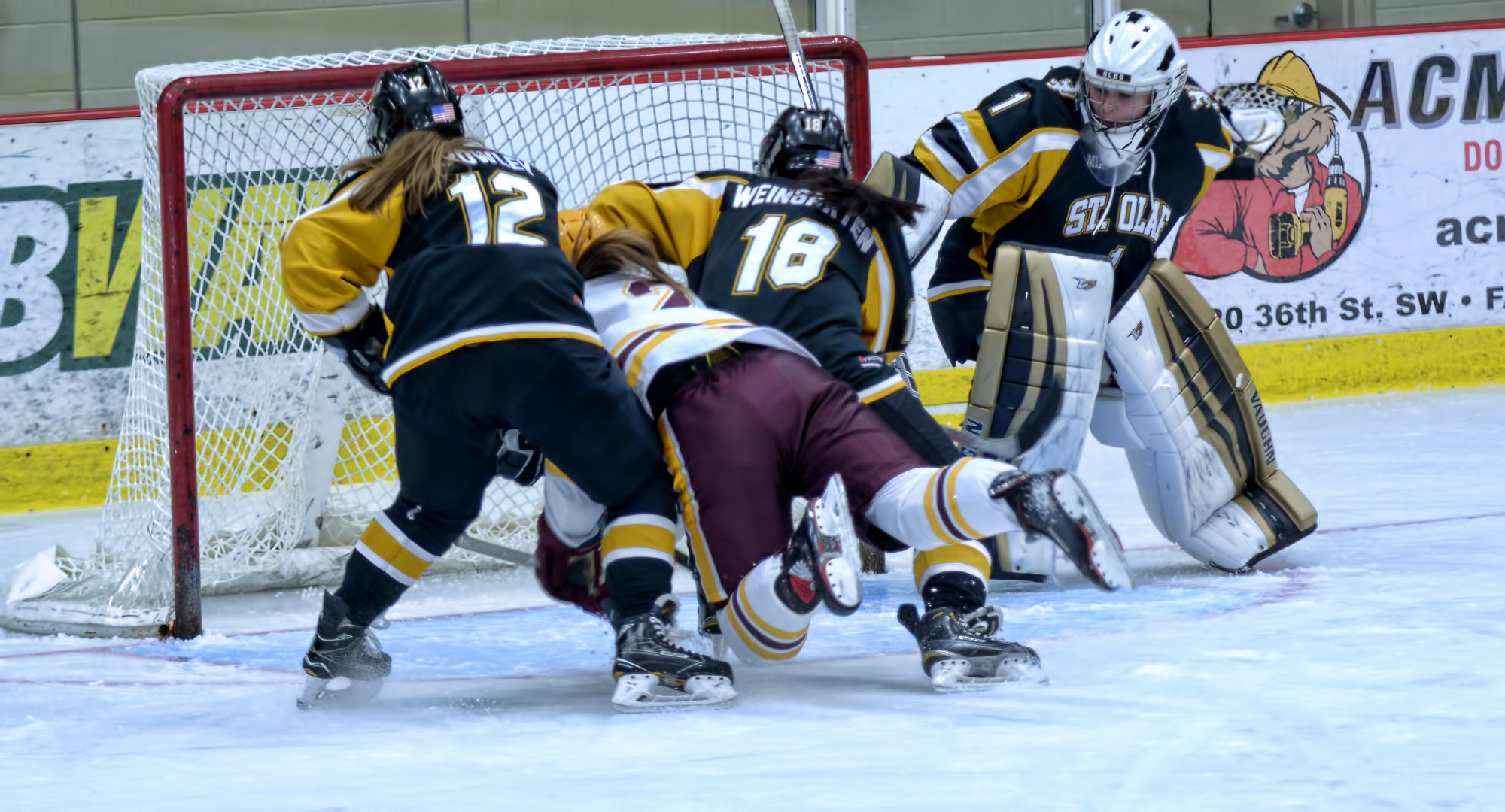 Amanda Flemming dives between two St. Olaf players to tap in a goal during the second period of the Cobbers' 5-3 win over the Oles.