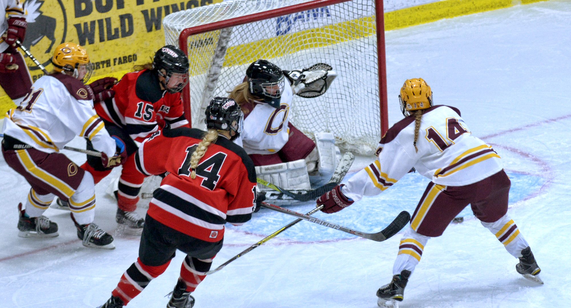 Callie Fagerstrom (#14) clears out the front of the net for Brittany Boss to make a save. Fagerstrom had a goal and an assist in the Cobbers' series with #7 Wis.-River Falls.