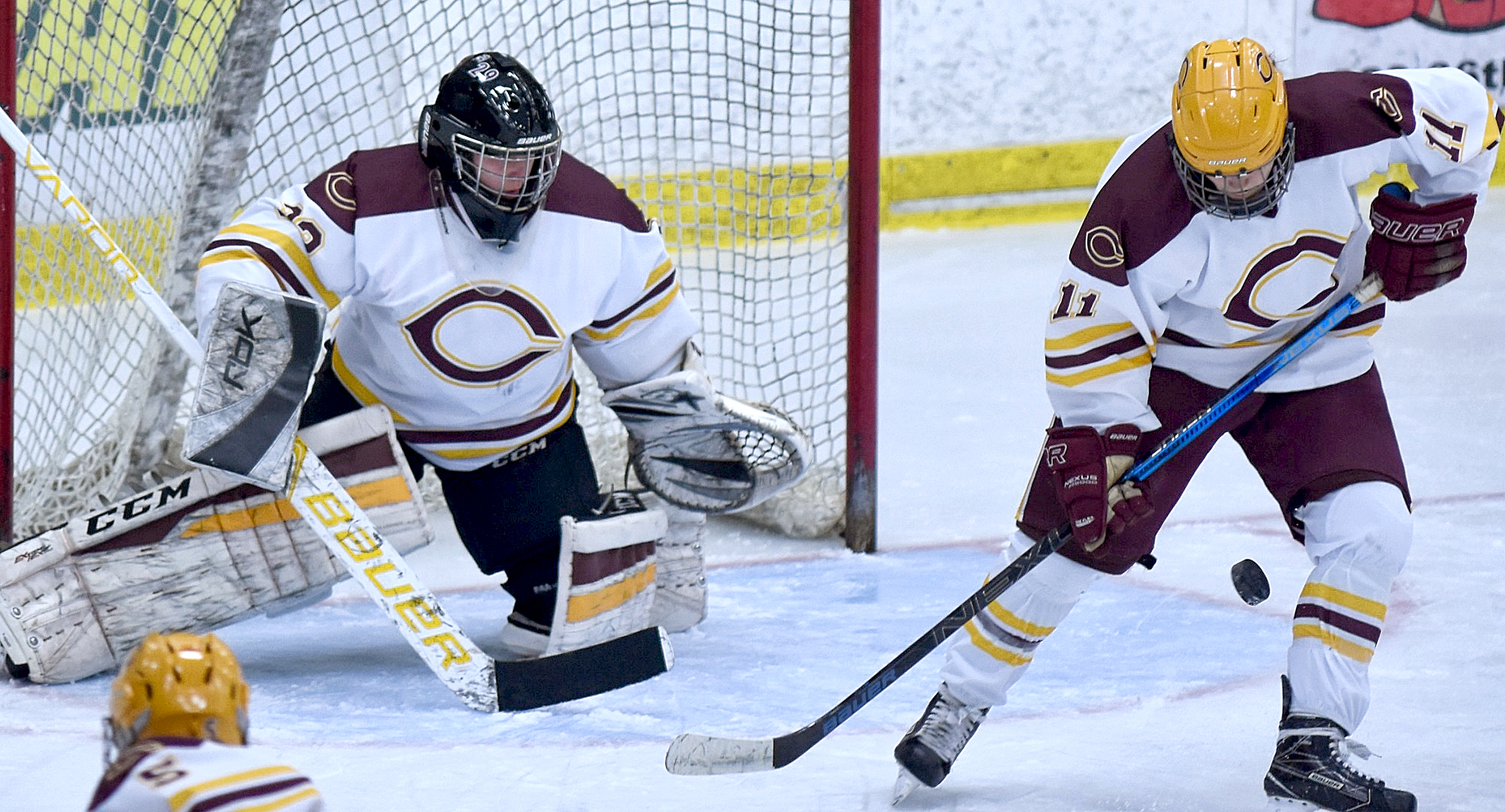Freshman goalie Emily Musielewicz watches junior defenseman Maddie Ellingson stop the puck during the Cobbers' 3-1 over Bethel.