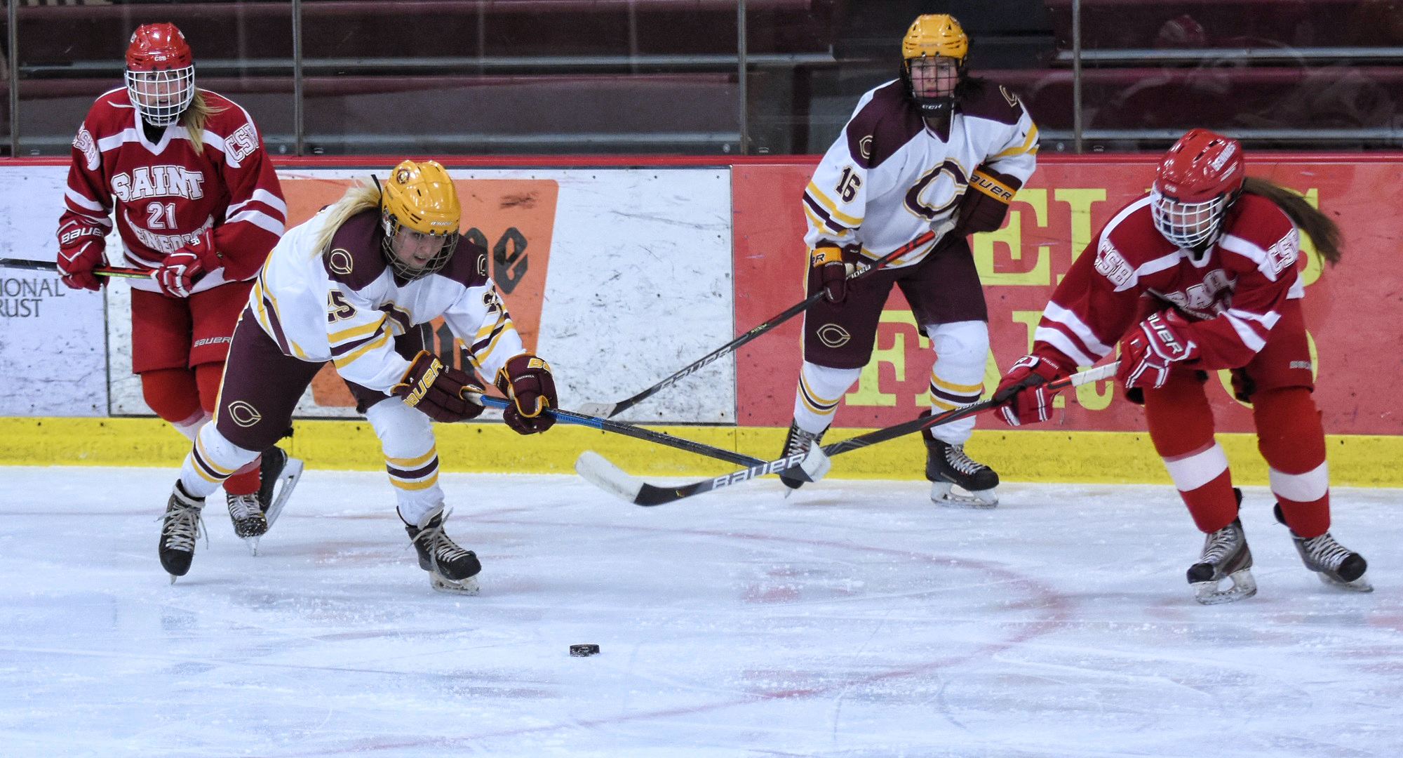Anna Ballweber (#25)  goes after the puck while teammate Brenna Mjoness looks on. The two combined for the Cobbers' first goal in the 2-1 win over St. Benedict.