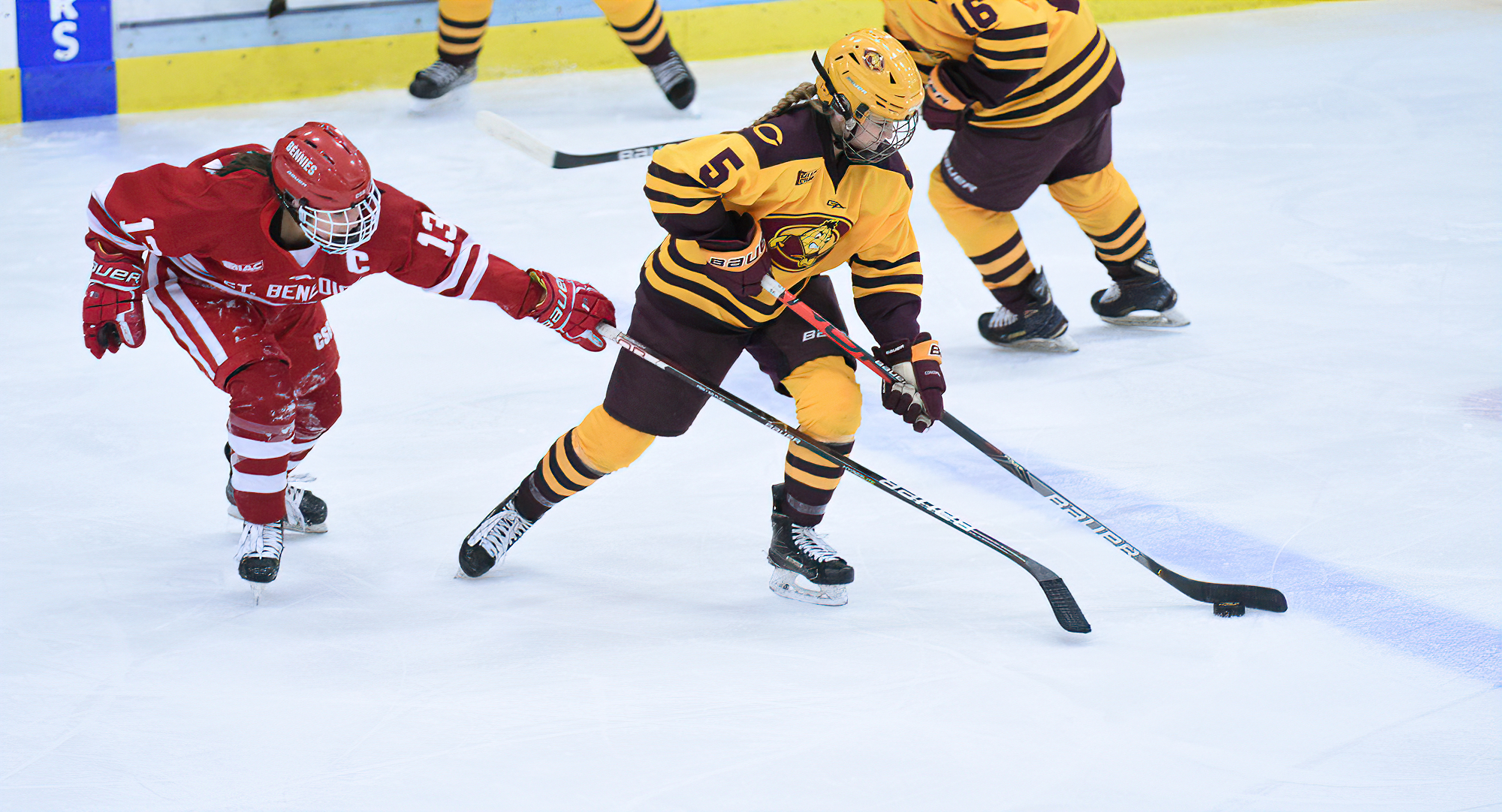 Junior McKenzie Oelkers takes the puck away from St. Ben's player during the series opener. She scored one of the two Cobber goals in the game.