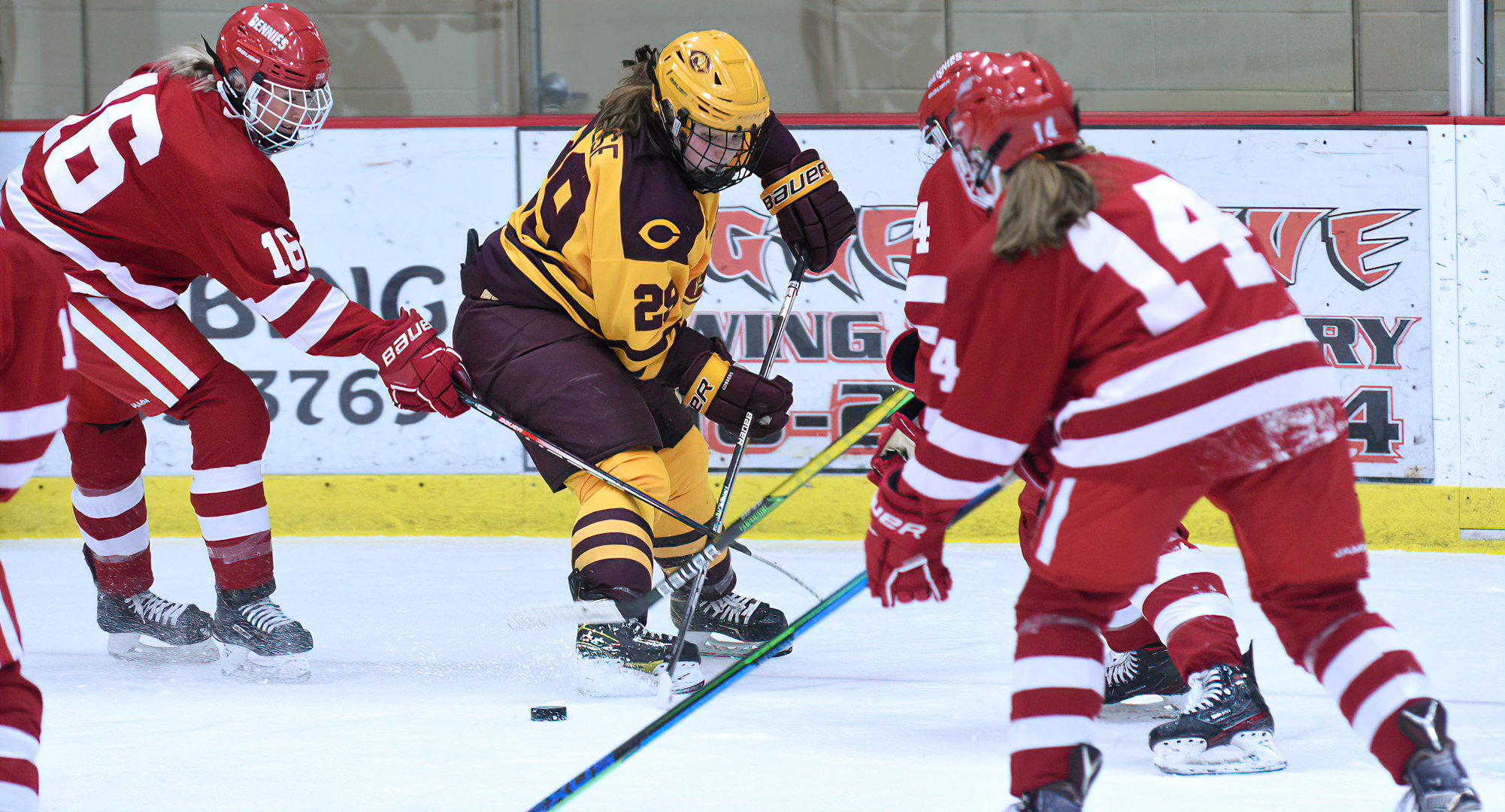 Sophomore Jerica Friese carries the puck towards the goal in between three St. Ben's defenders during the Cobbers' 1-1 OT tie in the series finale.