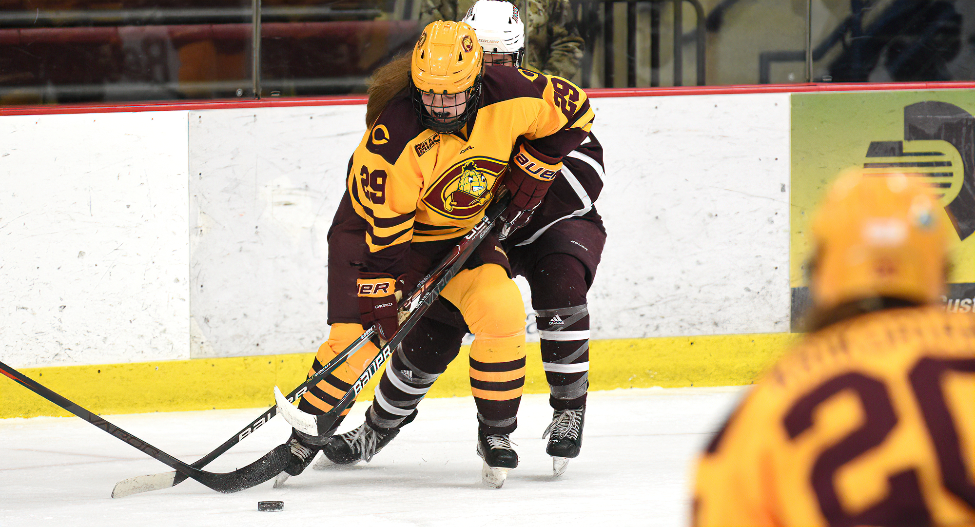 Jerica Friese controls the puck against an Augsburg defender. She scored the lone goal for the Cobbers in the series opener with the Auggies.
