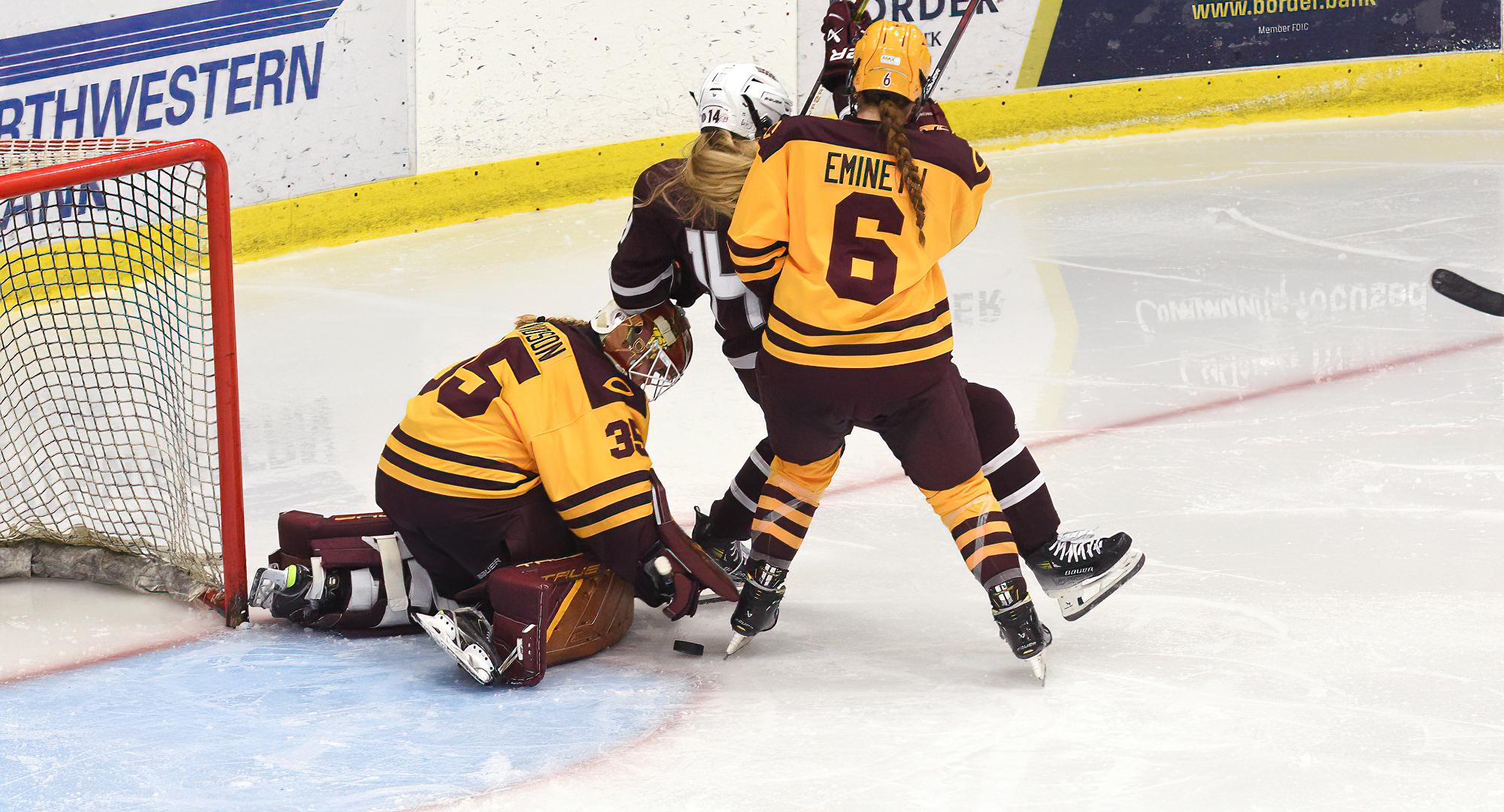 Senior goalie Ashlea Arvidson makes a stop, while Allie Emineth clears out a would-be goal scorer, in the Cobbers' season opener vs. Augsburg.