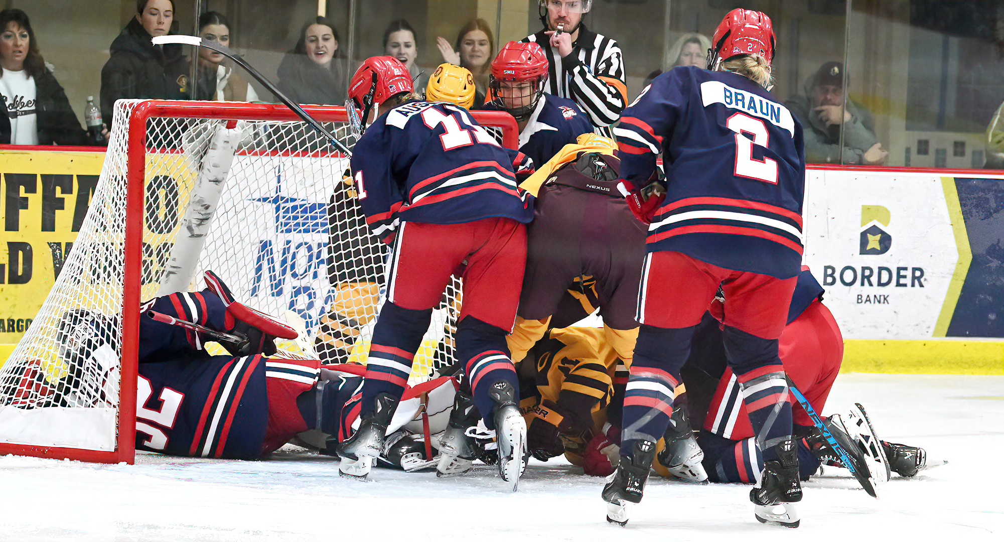 Players pile in on the St. Mary's goal during the third period of the Cobbers' series finale with the Cardinals.