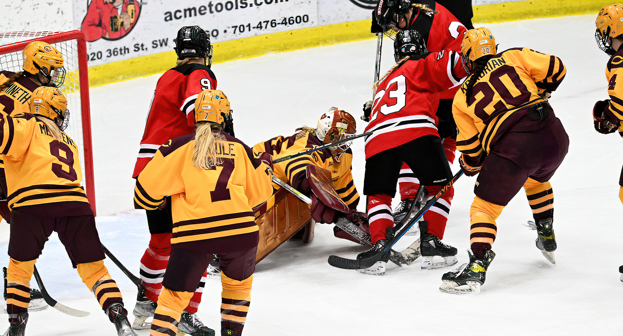 Goalie Ashlea Arvidson dives through a pack of players to cover the puck in the Cobbers' series finale with #2 Wis.-River Falls.