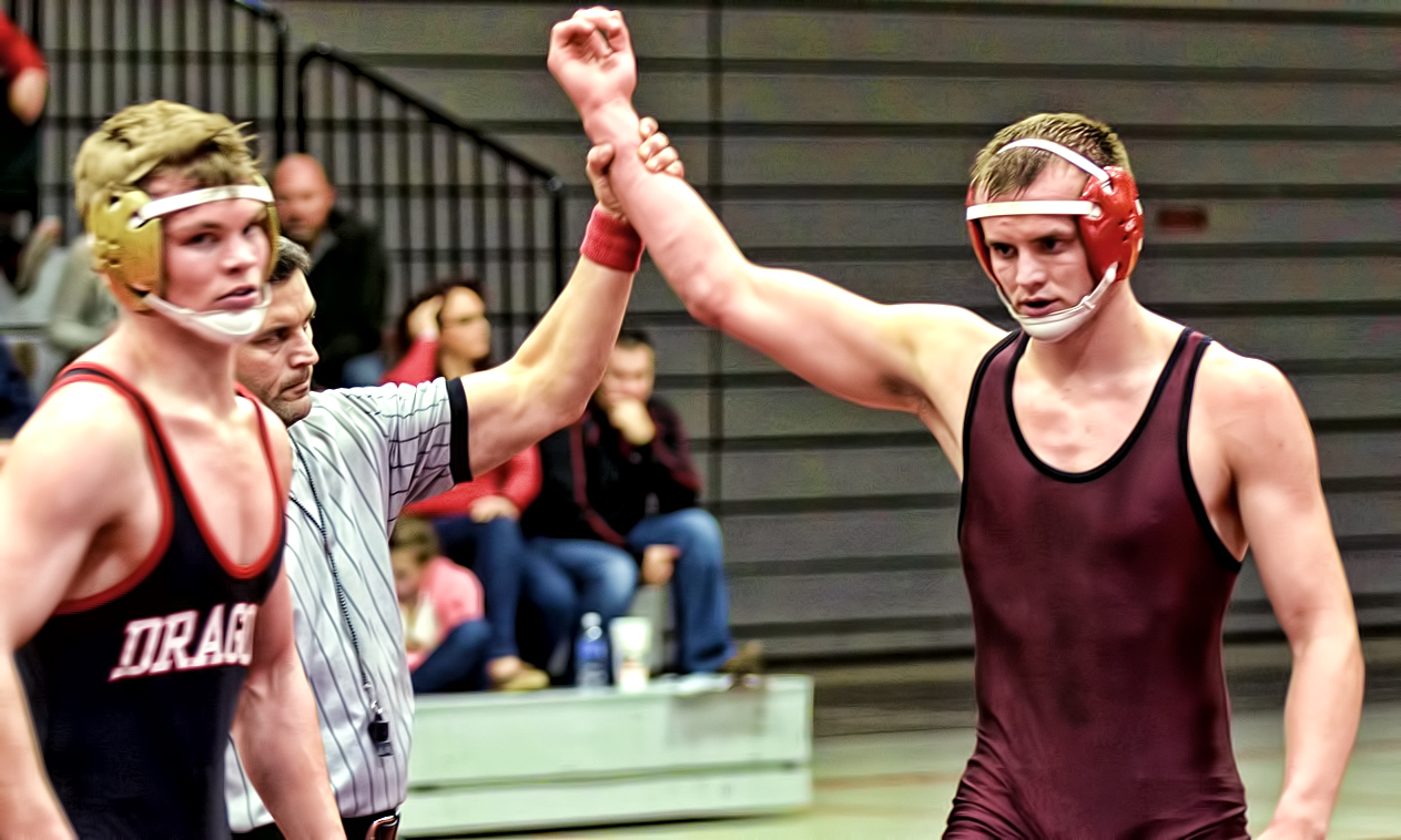 Freshman Parker Jackson has his arm raised after winning his match at 165. Jackson was one of three first-year athletes to earn wins against MSU Moorhead.