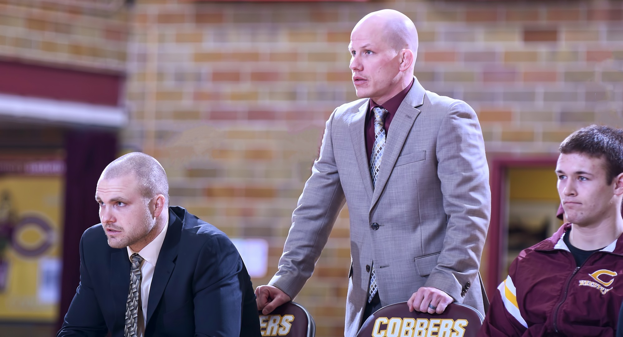 Quincy Osborn (middle) was named the head coach for the Cobber wrestling program.
