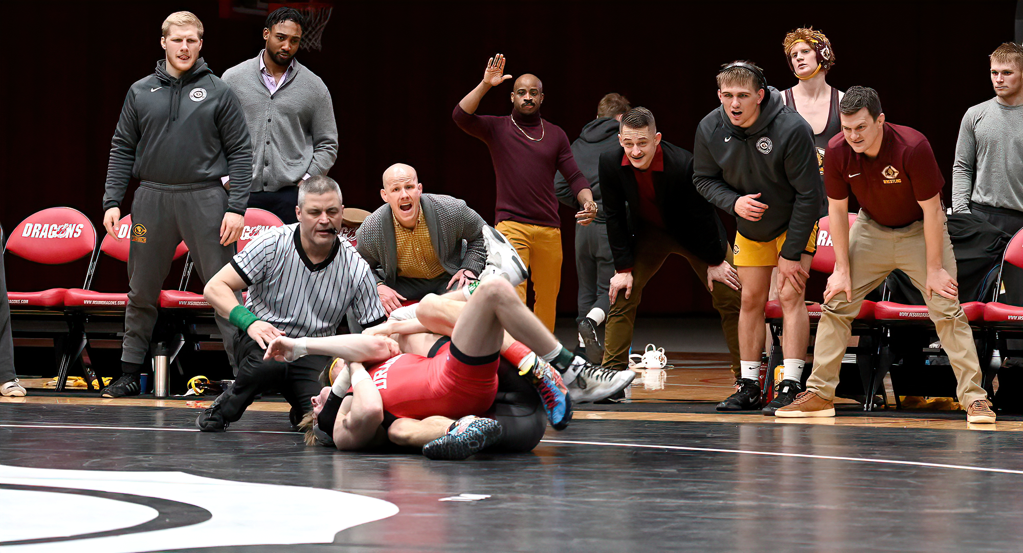 Sophomore Kie Anderson gets the pin in his match at 125 under the watchful eye of the Cobber bench in CC's 27-17 win at MSU Moorhead.