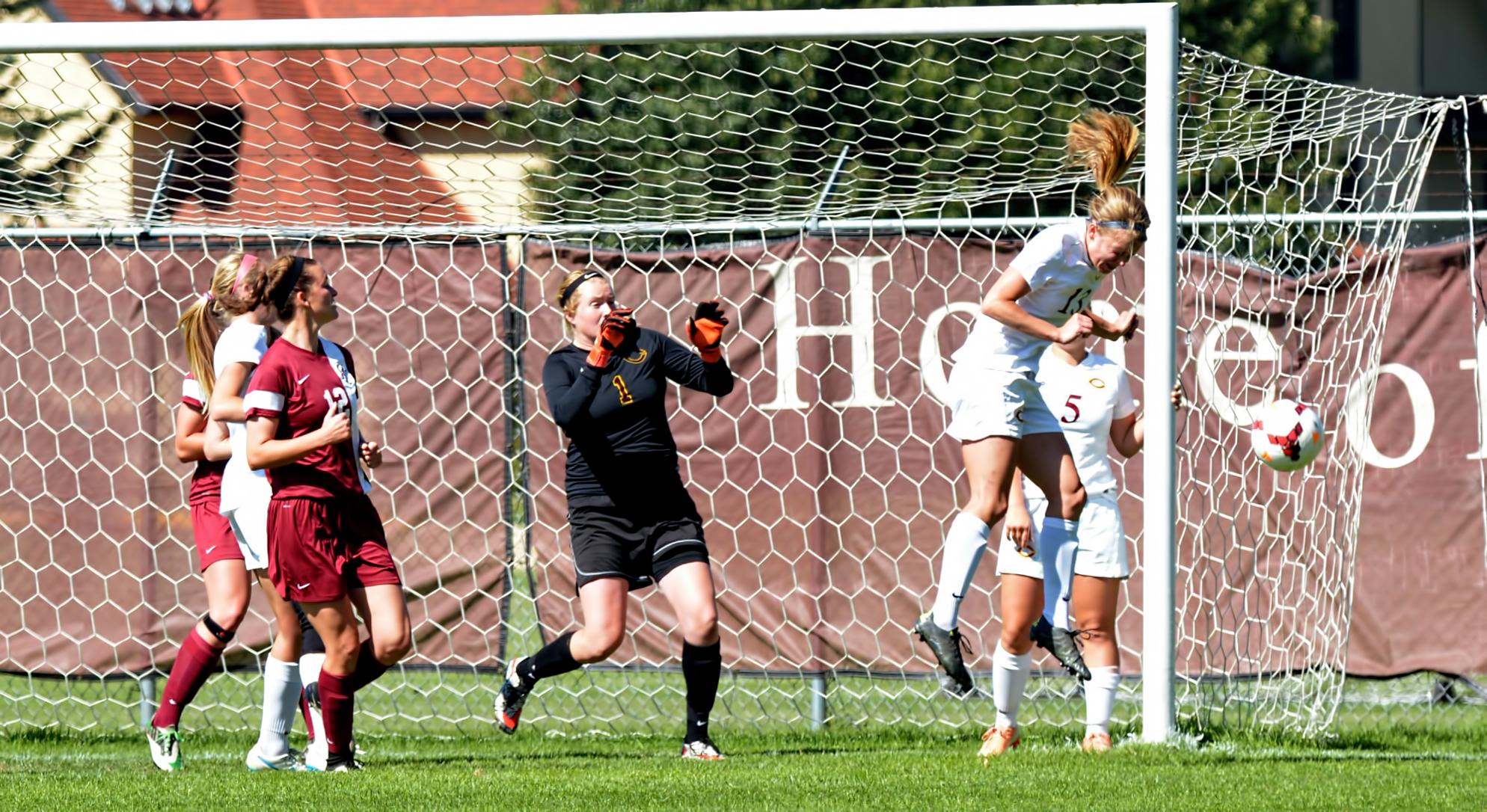 Senior defender Carly Mickelson heads the ball away from goal in the Cobbers' MIAC opener against Hamline.