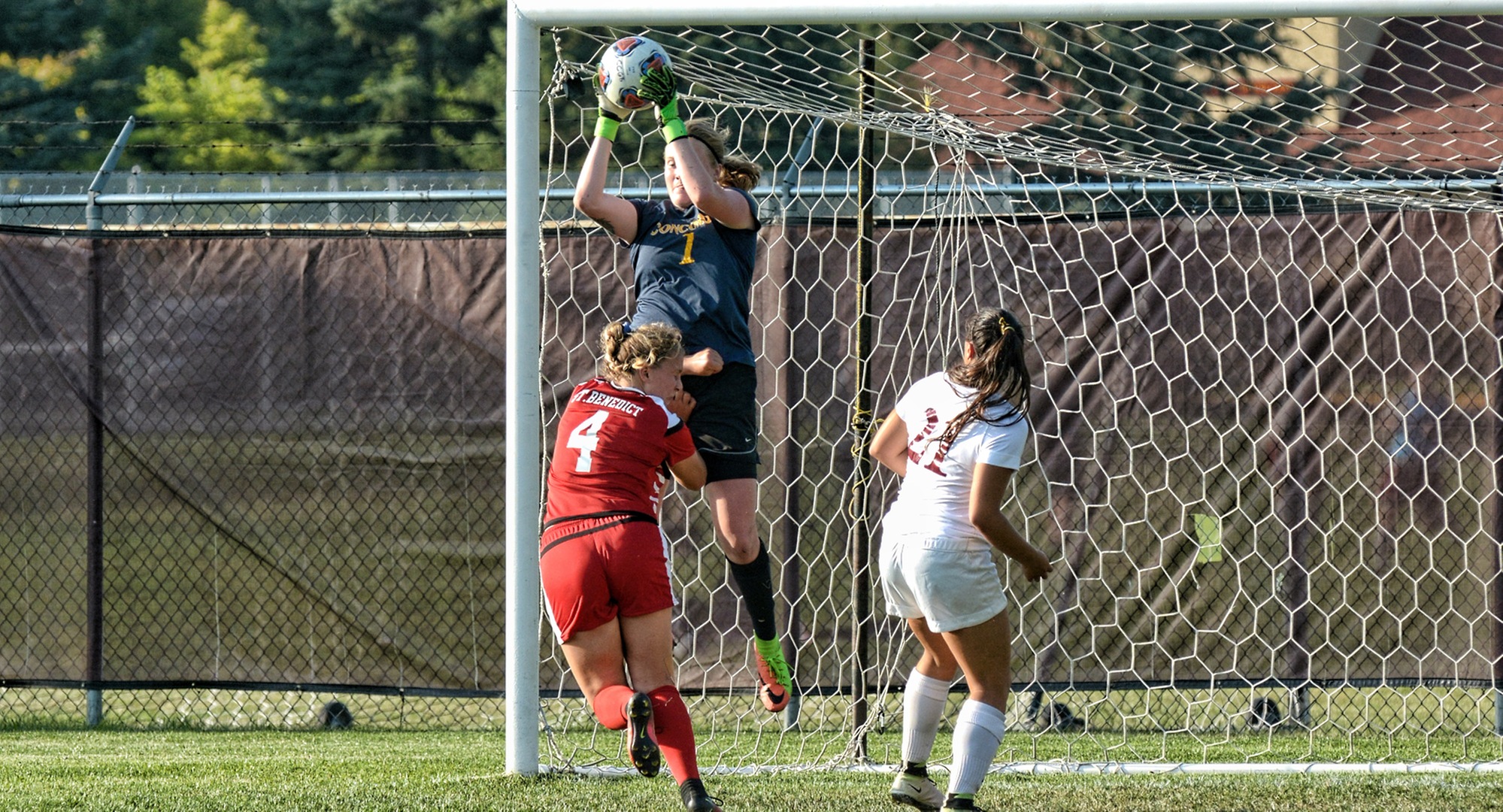 Concordia junior goalie Maddy Reed rises above the competition as she snares a crossing attempt during the Cobbers' MIAC opener with St. Ben's.