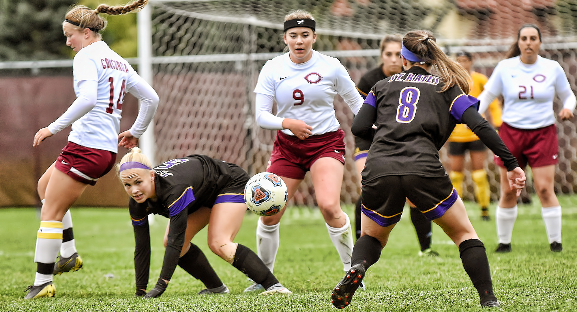 Freshman Grace Lawlor (#9) defends against a pair of St. Catherine attackers. Lawlor had the Cobber goal against the Wildcats.