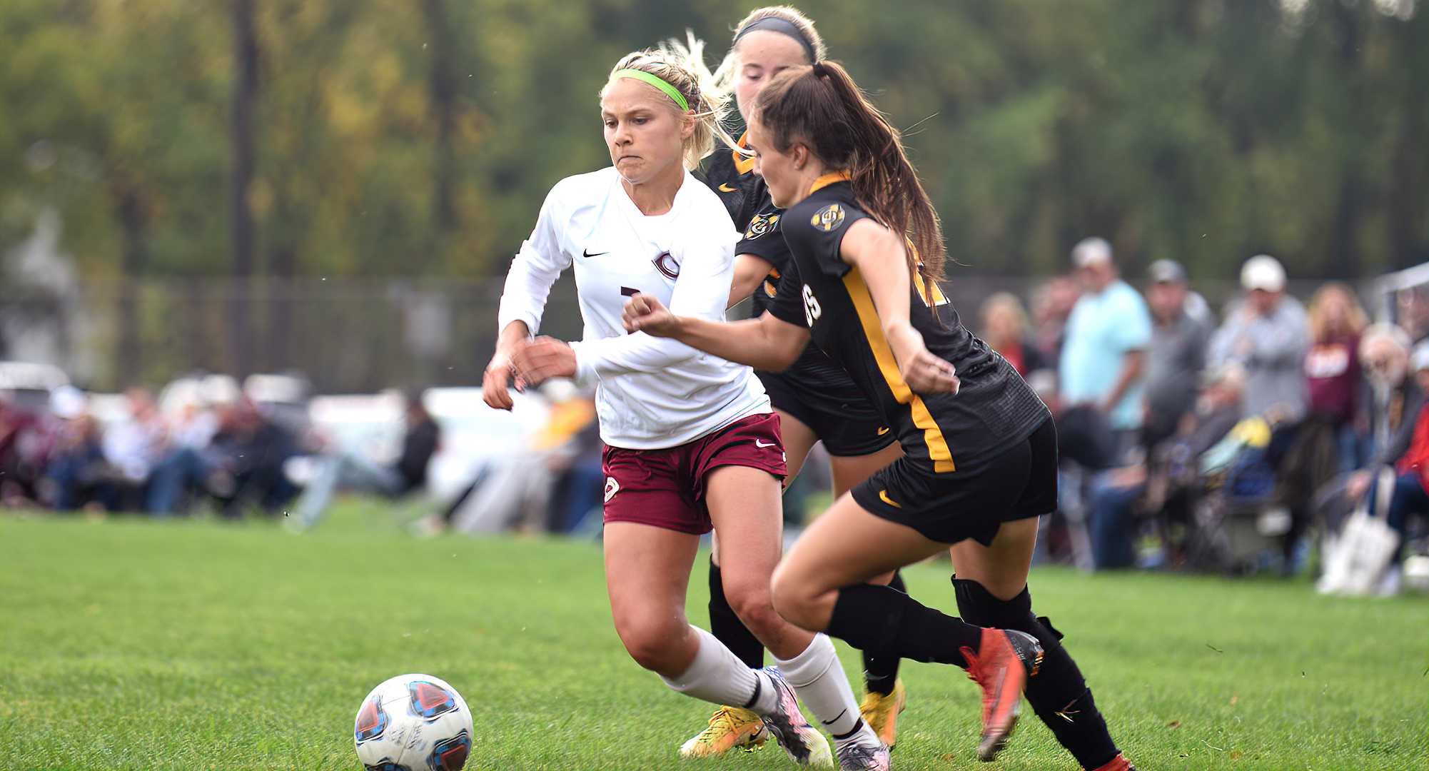 Senior Lauren Tschider dribbles past a pair of Gustavus defenders. She had the Cobbers' goal in the MIAC match-up with the Gusties.