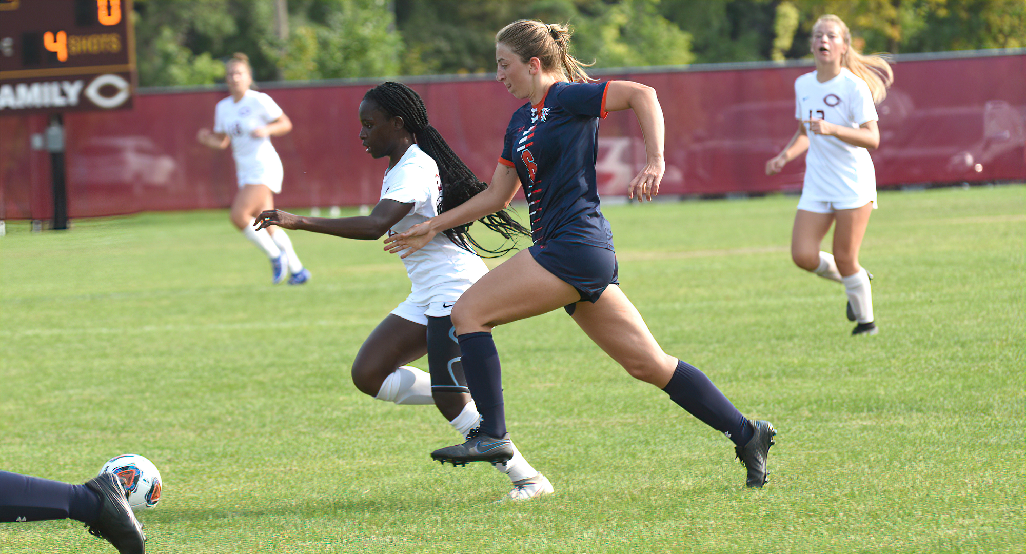 Freshman Hannah Mukhtar races past a Macalester defender during the first half of the Cobbers MIAC opener against the Scots.