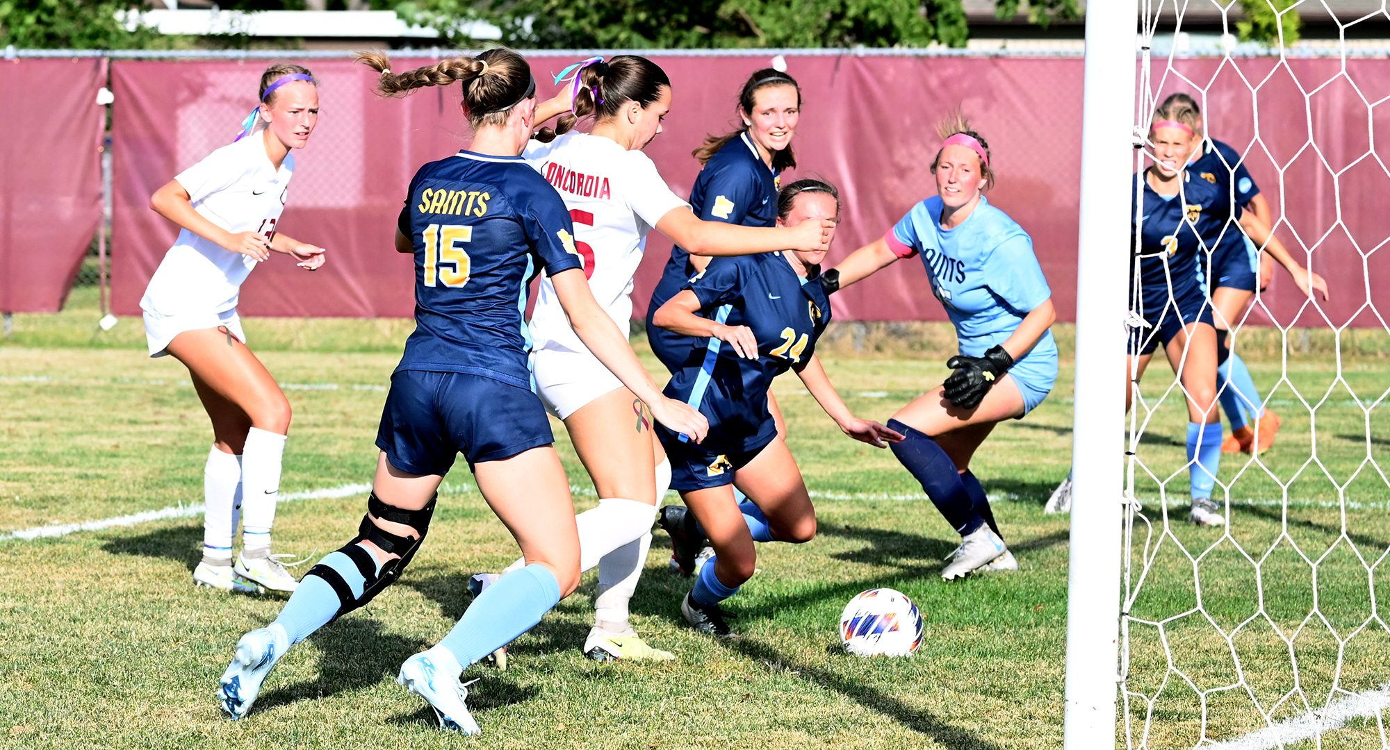 Reese Christ (middle) gets ready to poke home the ball for the Cobbers' second goal in CC's 2-0 win over St. Scholastica.