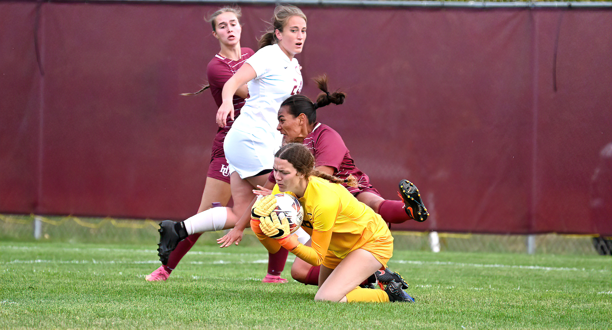 Senior goalie Kaitlin Petrich comes out to make a save in front of a Hamline attacker in the Cobbers' 1-0 win over the Pipers.