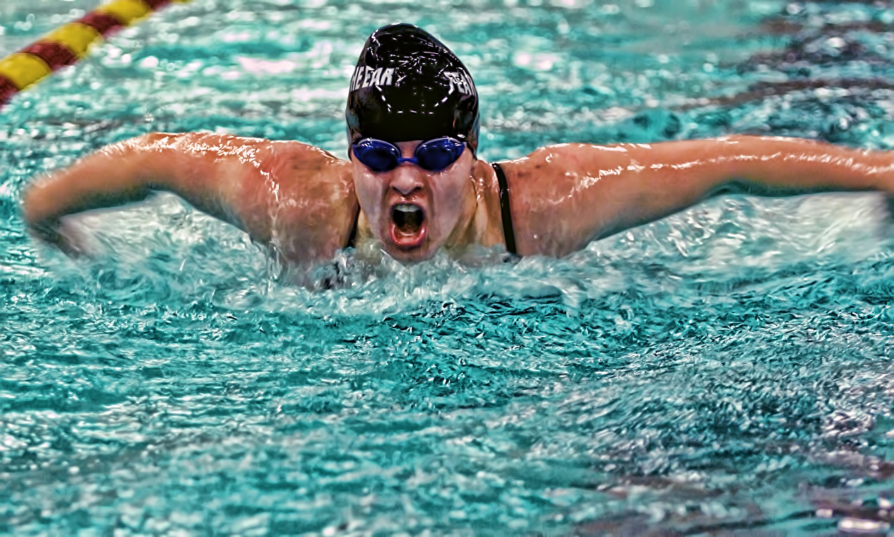 Junior Sarah Nelson races towards the wall in the 100-yard butterfly. She finished second in the event and won the 100-yard freestyle.