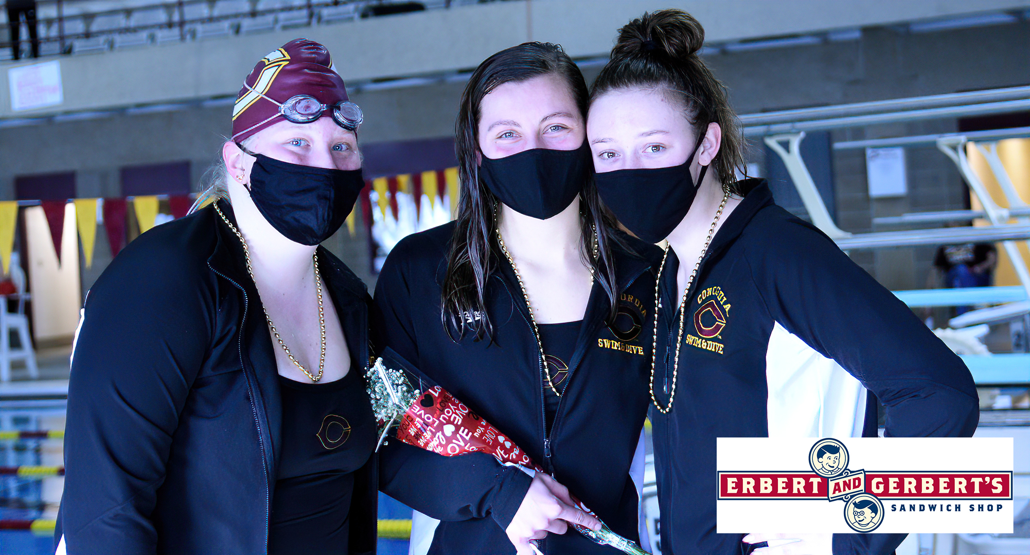 Senior Anna Backes (M) was honored by teammates, and received gifts from Lindsey Biebl (L) and Alex Rasmussen, during the Cobbers' dual meet with Augsburg. Backes won the 200 IM and 500 Free to help CC win 83-71.