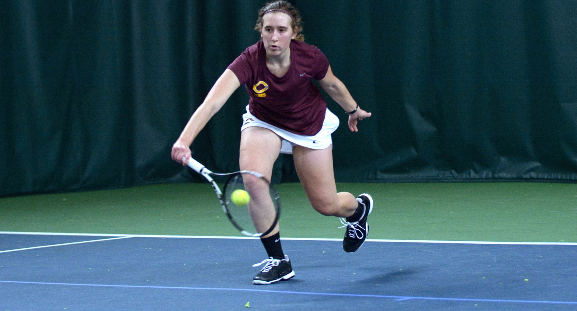 Sophomore Lisa Neumann goes down to return a shot during her 6-1, 6-0 win at No.2 singles in the Cobbers' season opener.