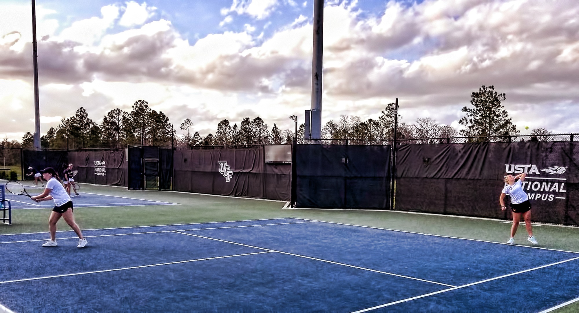 The doubles team of Lexi Johnson (R) and Josie Beachy serve during their match vs. Rose-Hulman. The duo were undefeated on the final day in Florida.