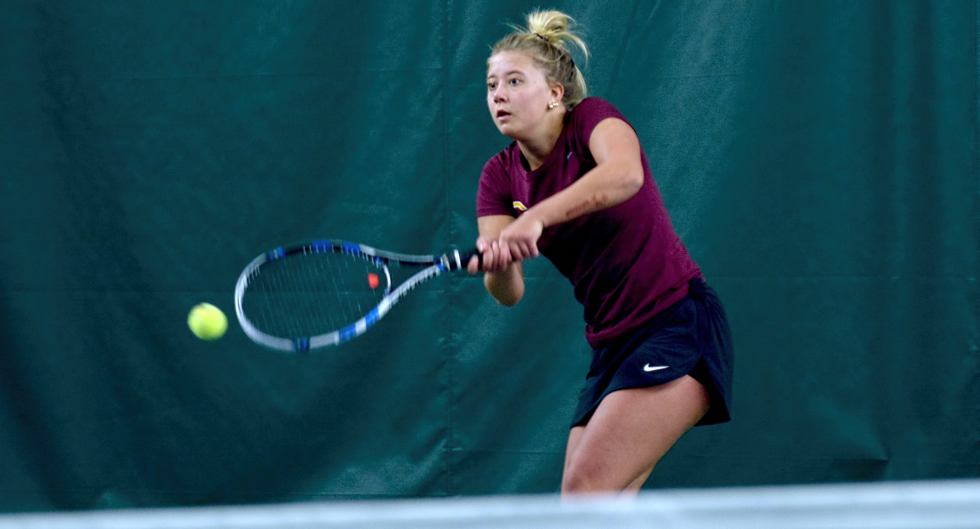 Freshman Josie Beachy hits a backhand return of serve during her match at No.5 singles during the Cobbers' match with St. Mary's.