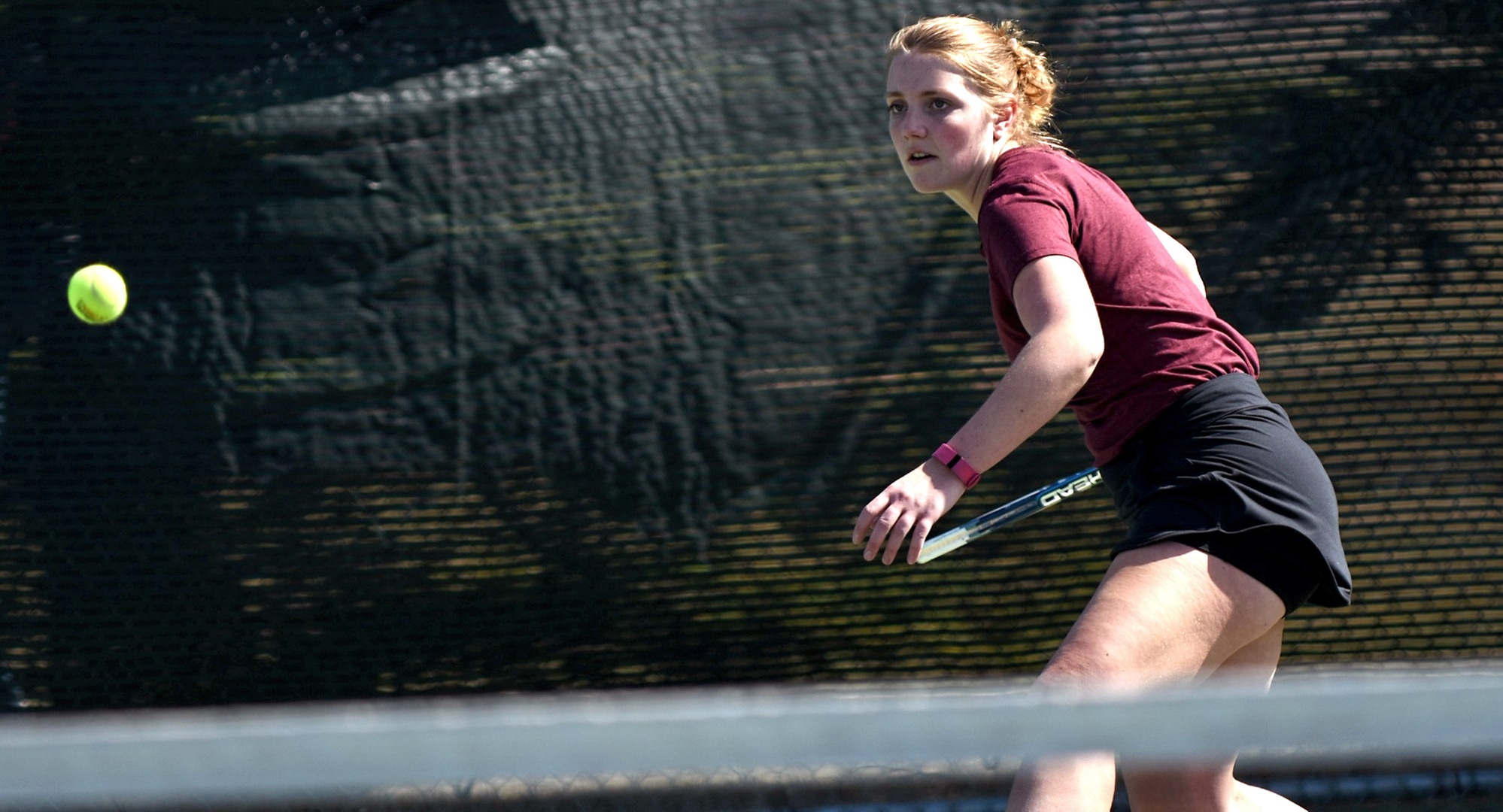 Senior Kendra Stoick eyes a forehand during her match at No.2 singles in the Cobbers' dual with Martin Luther. Stoick capped her career with a straight set win.