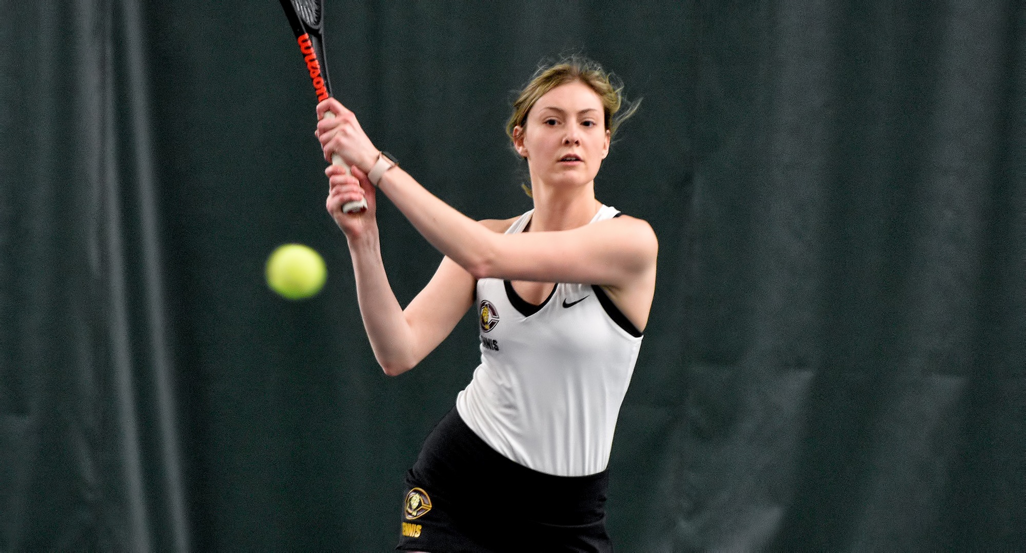 Junior Jenna Forknell eyes her backhand return during her match at No.2 singles in the Cobbers' home opener against St. Catherine.