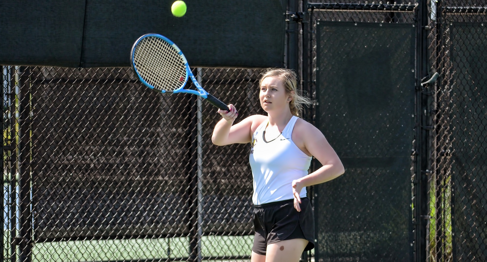 Sophomore Abby Westrum hits a forehand return at the USTA National Tennis Center. She recorded a win in her first singles match of the year and helped Concordia roll past Adrian. (Photo courtesy of Jeff Meyer)