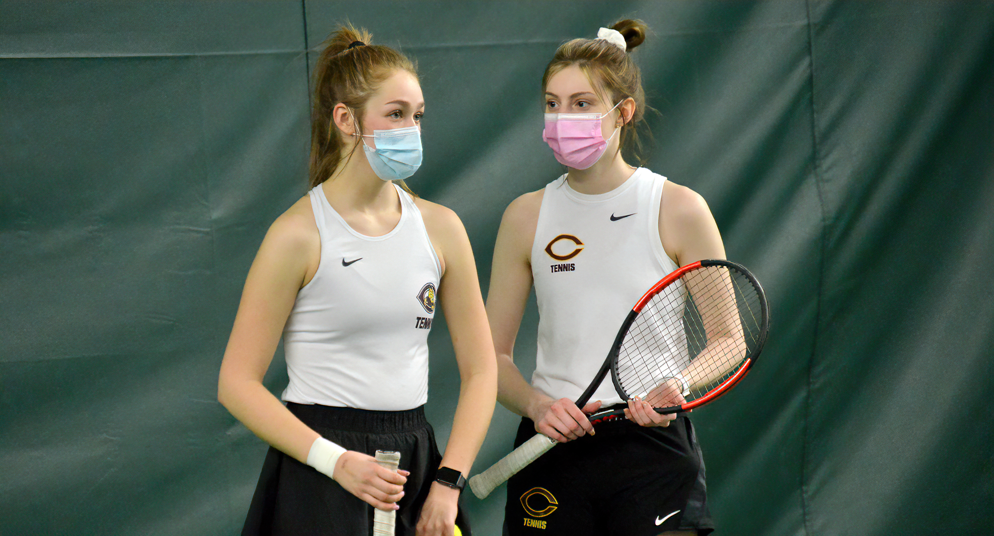 Raquel Egge (L) and Jenna Forknell talk over strategy during their match at No.1 doubles. The duo won 6-1, 6-3 and have won four of their last five matches.